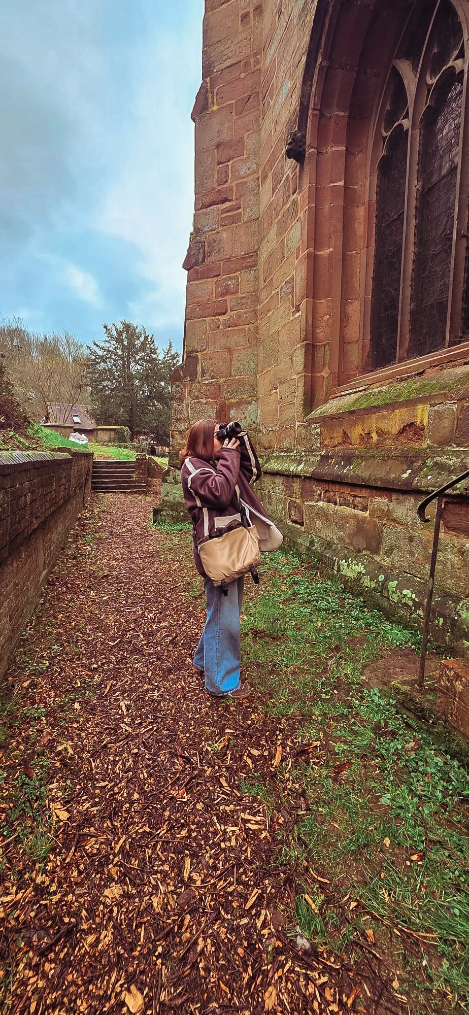 Shelley of Slow Bliss Studio taking photographs outside a church, slow and intentional brand photography
