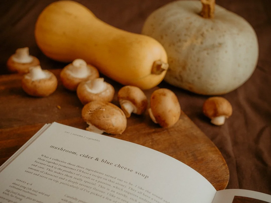 Recipe for mushroom, cider and blue cheese soup from Gill Meller's Time cookbook, arranged with fresh mushrooms, butternut squash and Crown Prince squash.