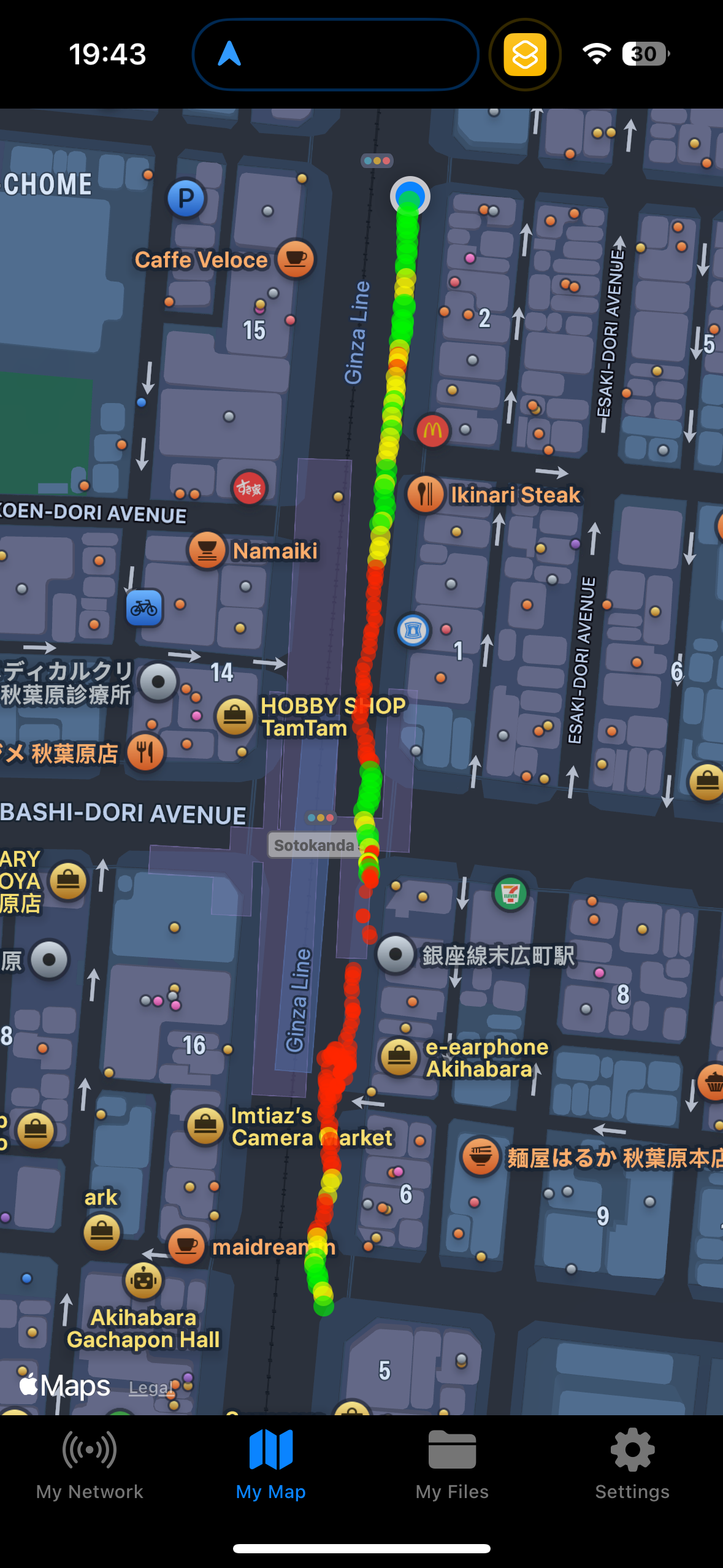 Screenshot of the nOversight app showing a map of Wi-Fi signal strength in a busy street in Tokyo highlighted by a colored markers. The connection is to an OpenRoaming network