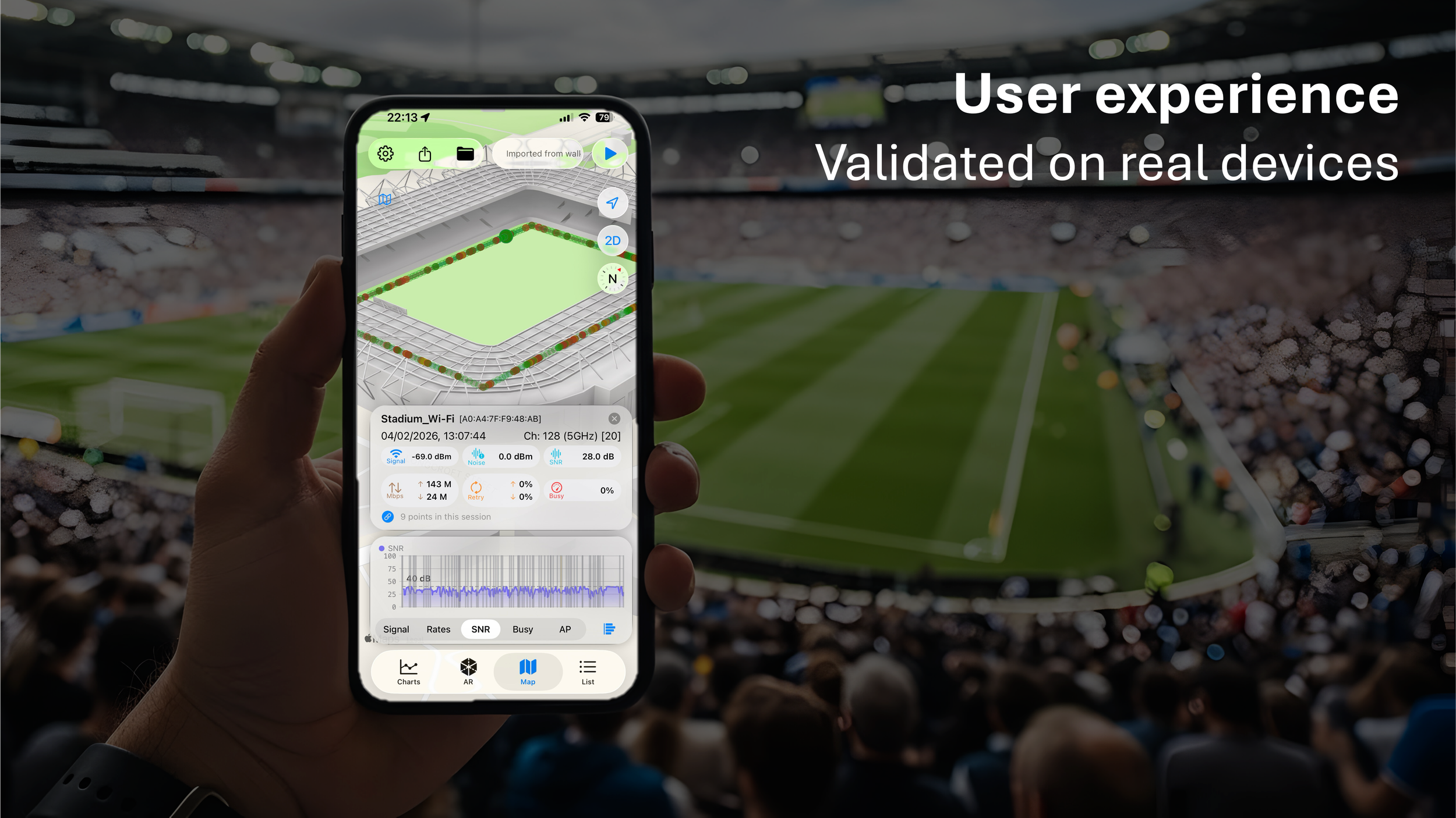 A person holding a smartphone with a stadium with the nOversight app showing Wi-Fi signal monitoring app on the screen, set over a crowded stadium with a soccer field in the background.