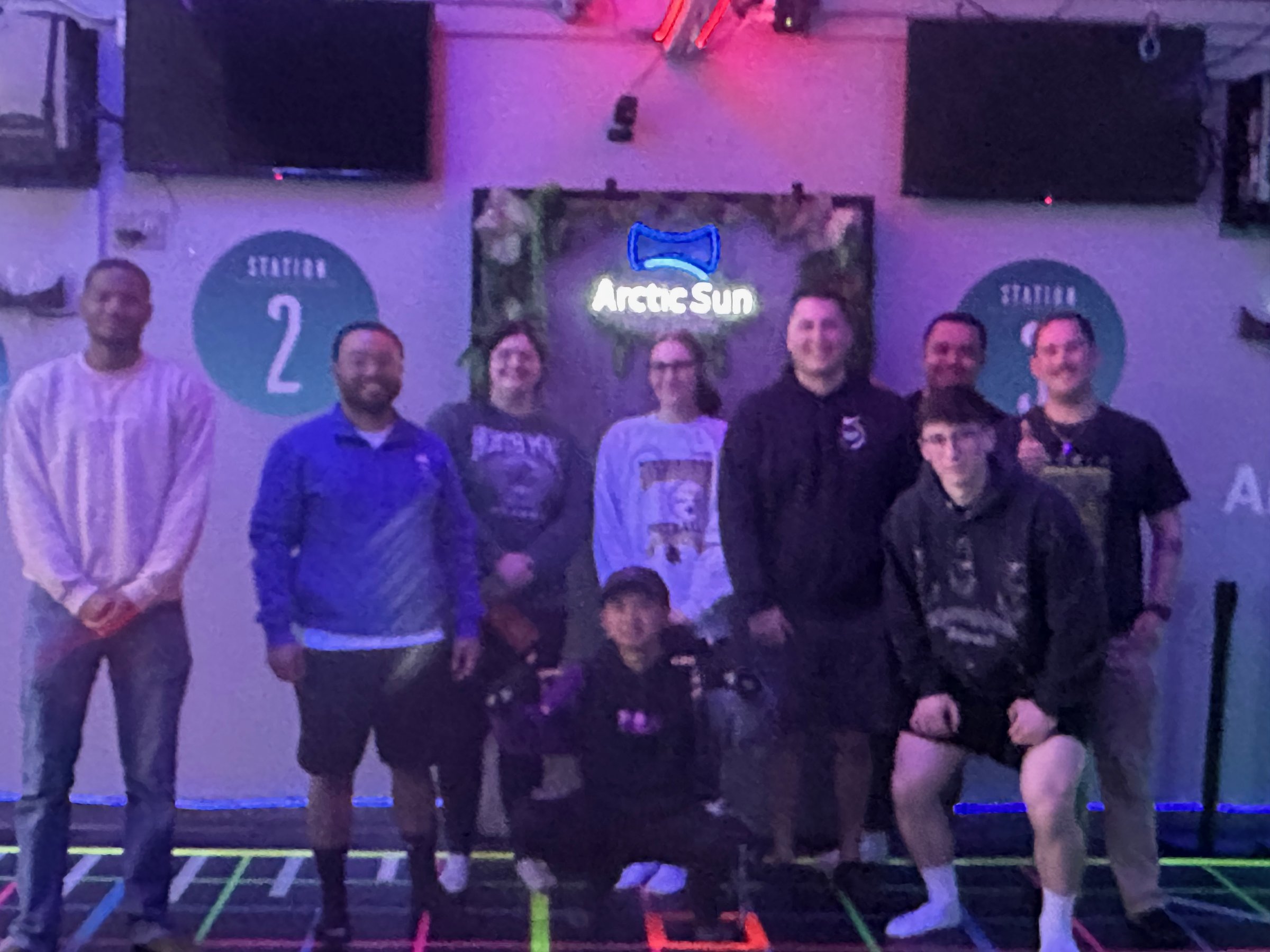 A group at the logo wall, 2025