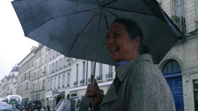 Stephanie Kalb holding an umbrella in the streets of Paris