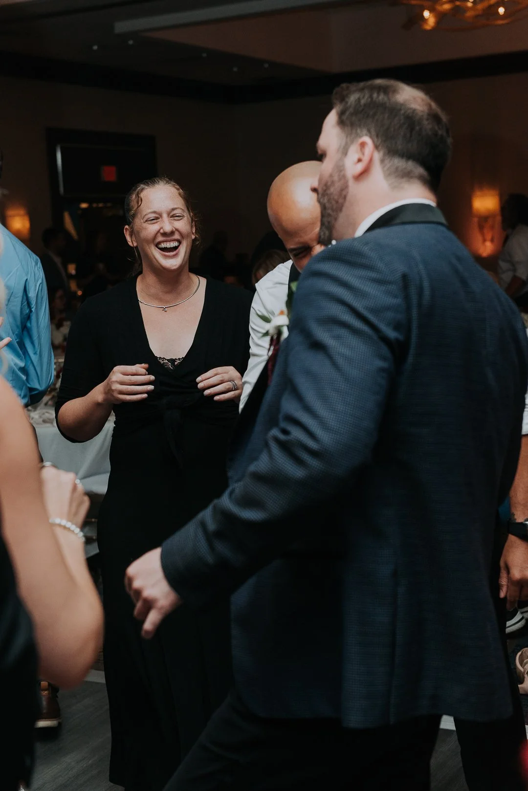 People enjoying themselves and laughing at a social gathering or party.