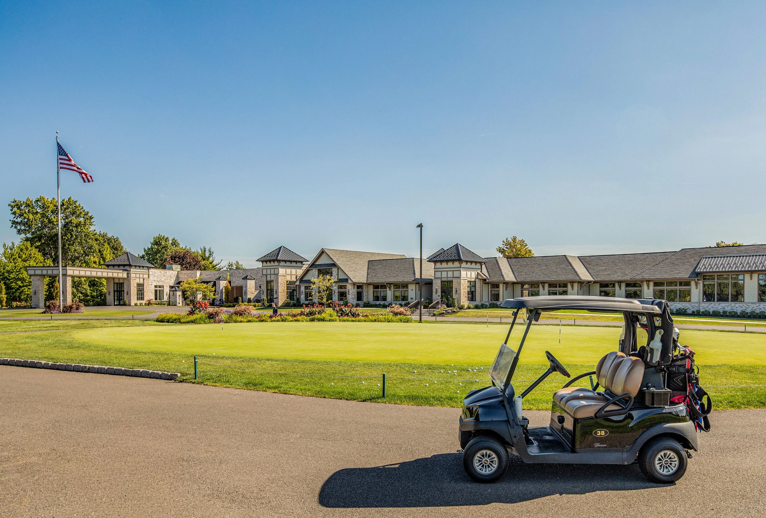 Brookfield Country Club with golf cart and gold balls in the front of the building