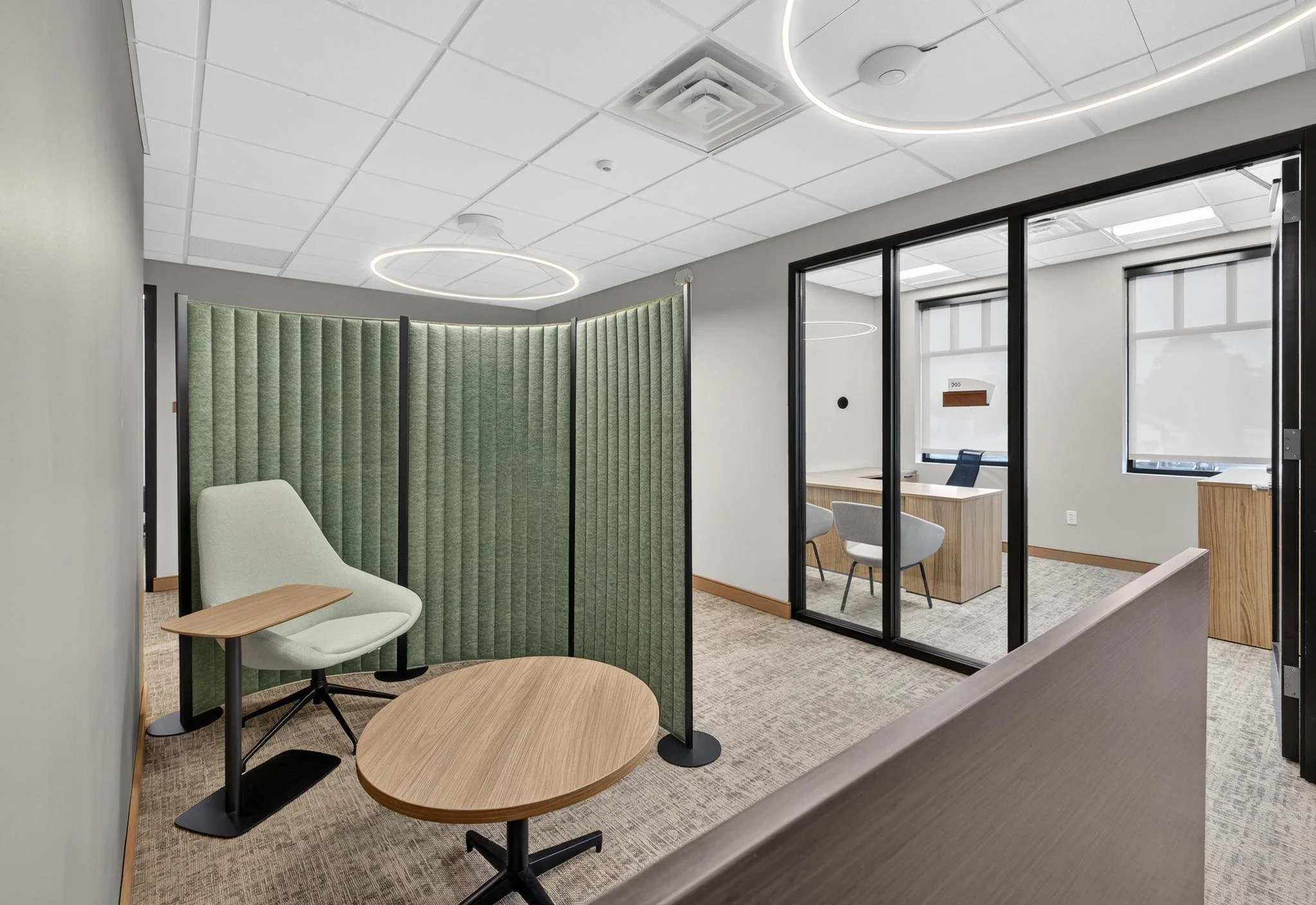 Modern office workspace with green chair and partition