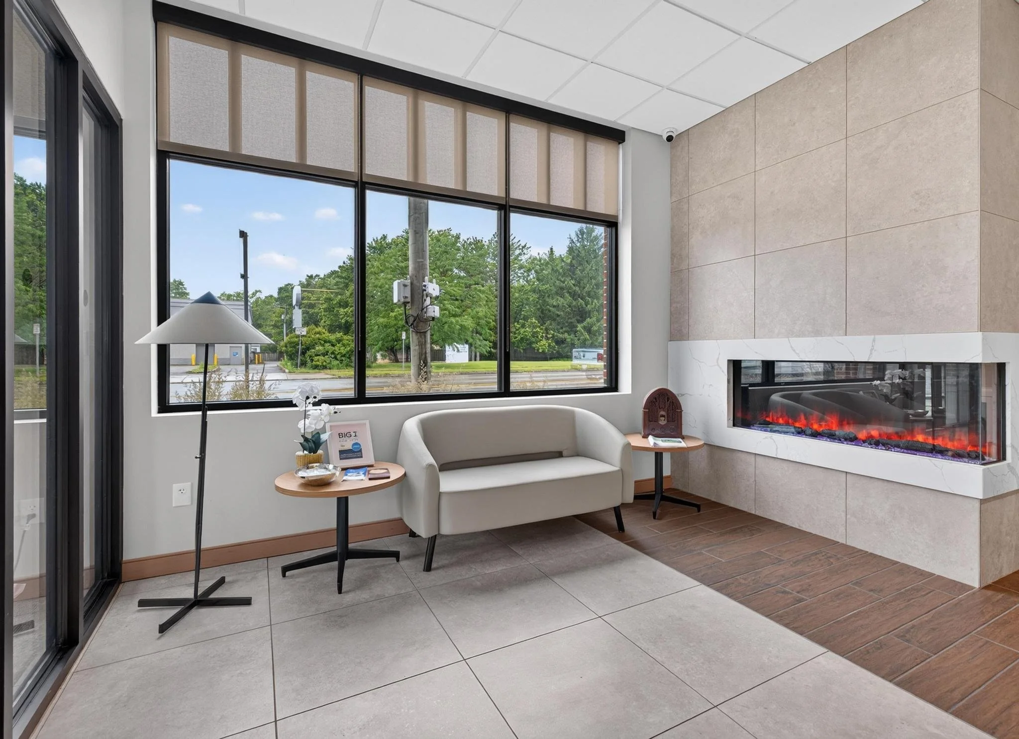 Insurance office entryway with fireplace and couch