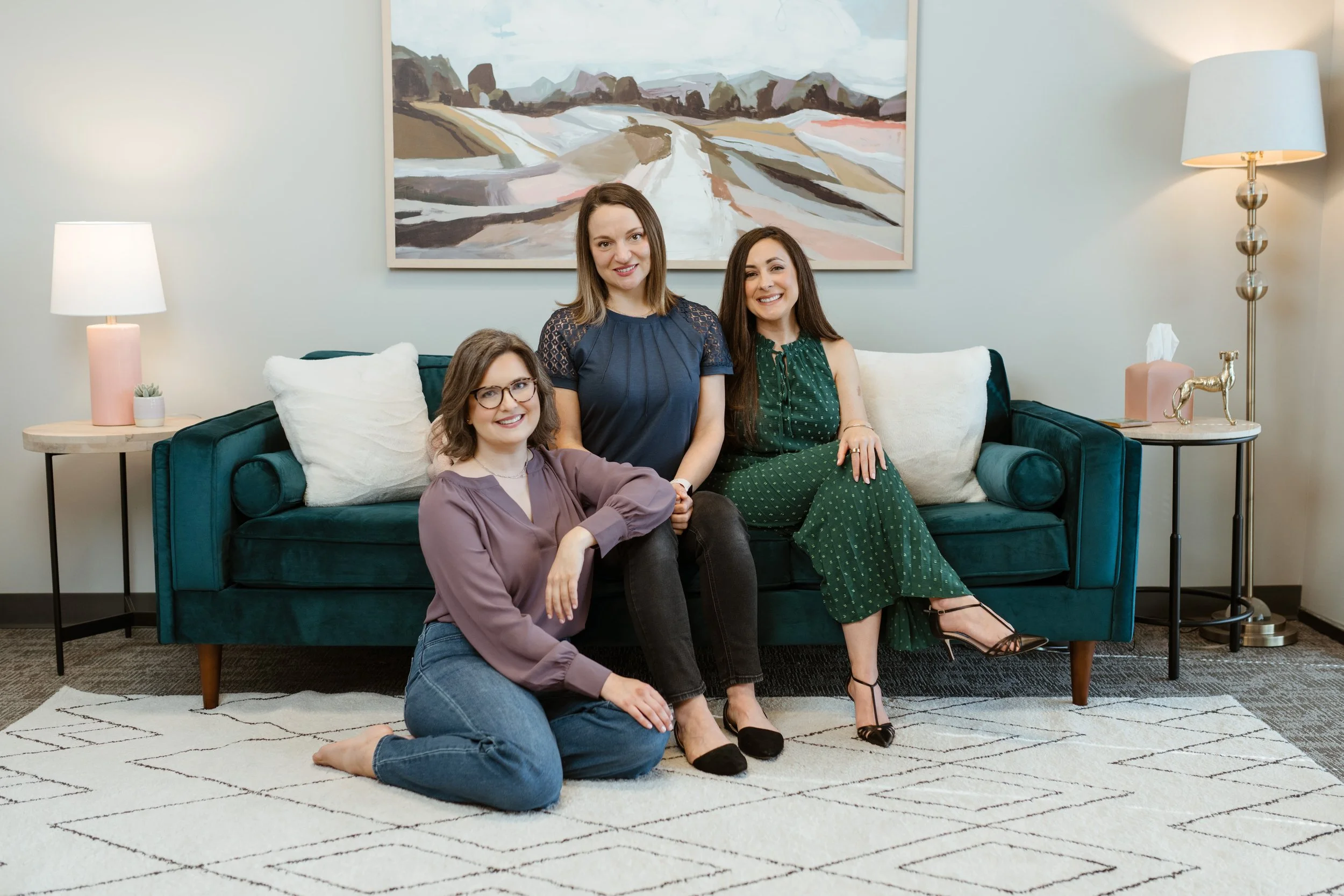 three Houston therapists sitting on a couch ready to help anxious humans