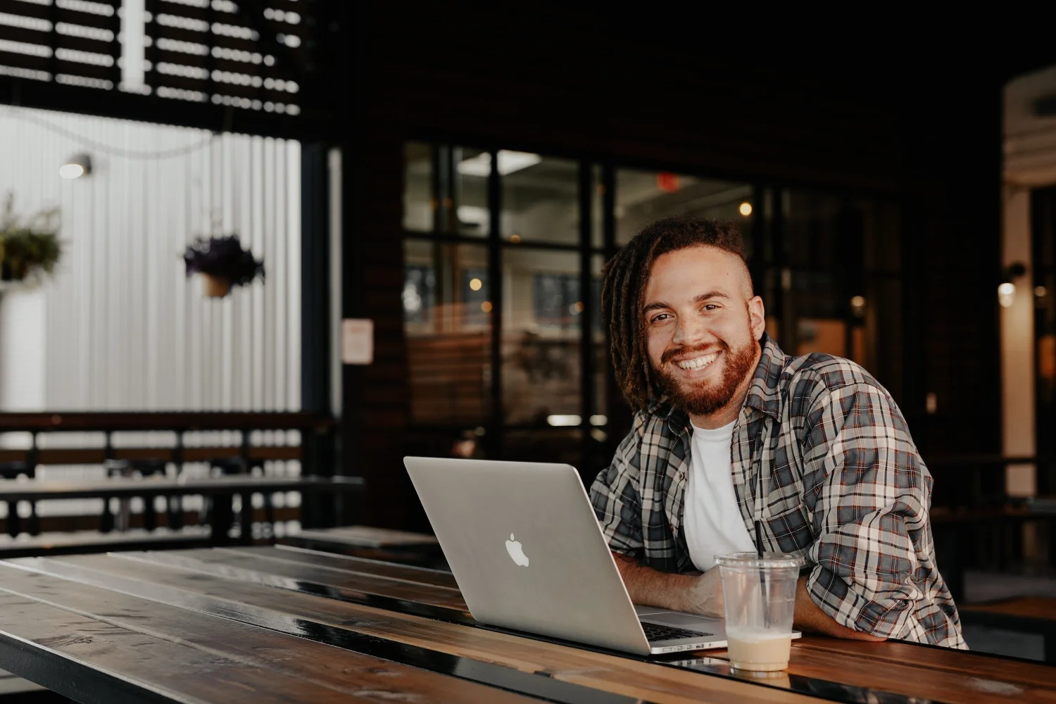 Person relaxing with a laptop and coffee