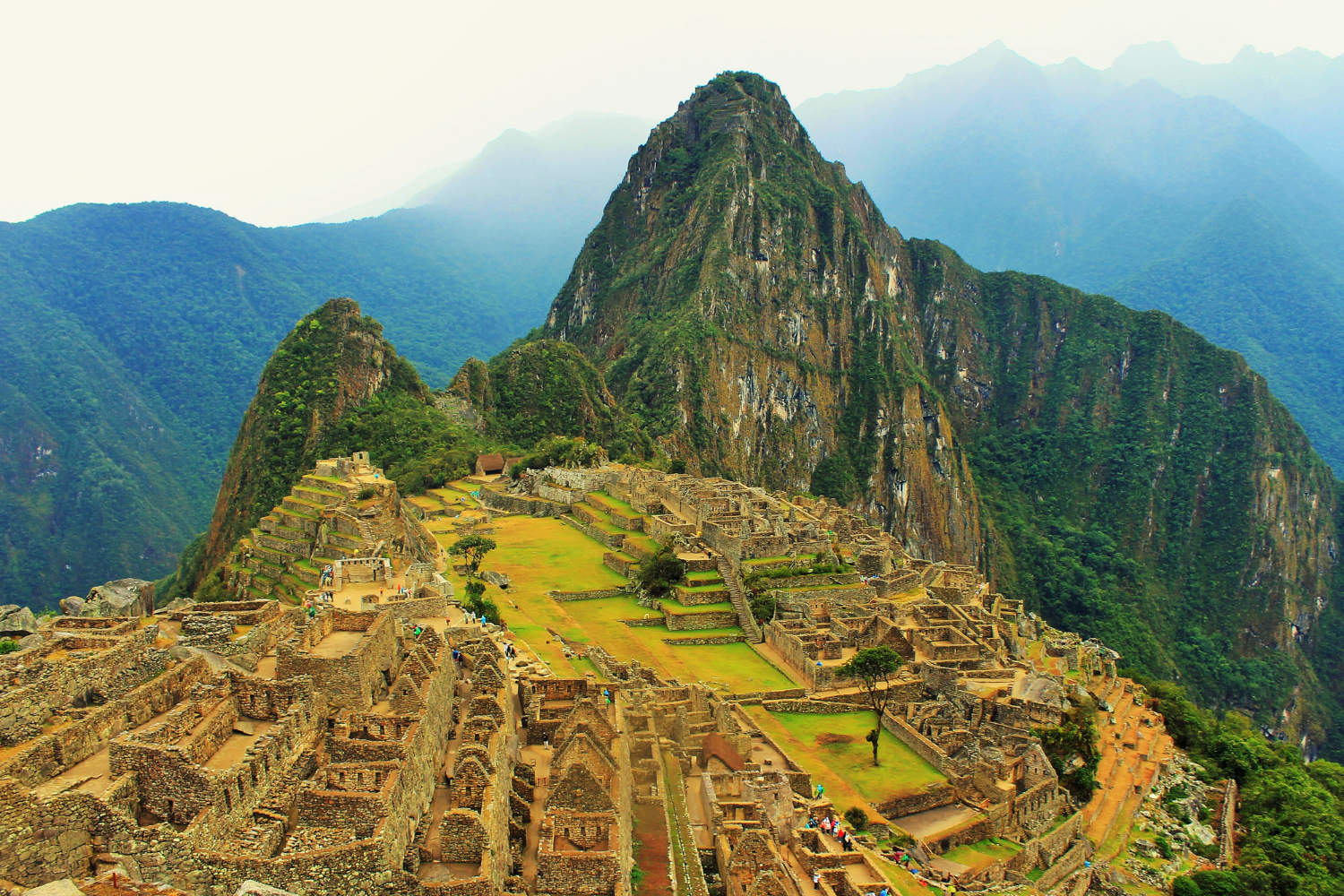 Machu Picchu Peru on a misty morning. Custom travel planned by Ask Ros, She Travels.