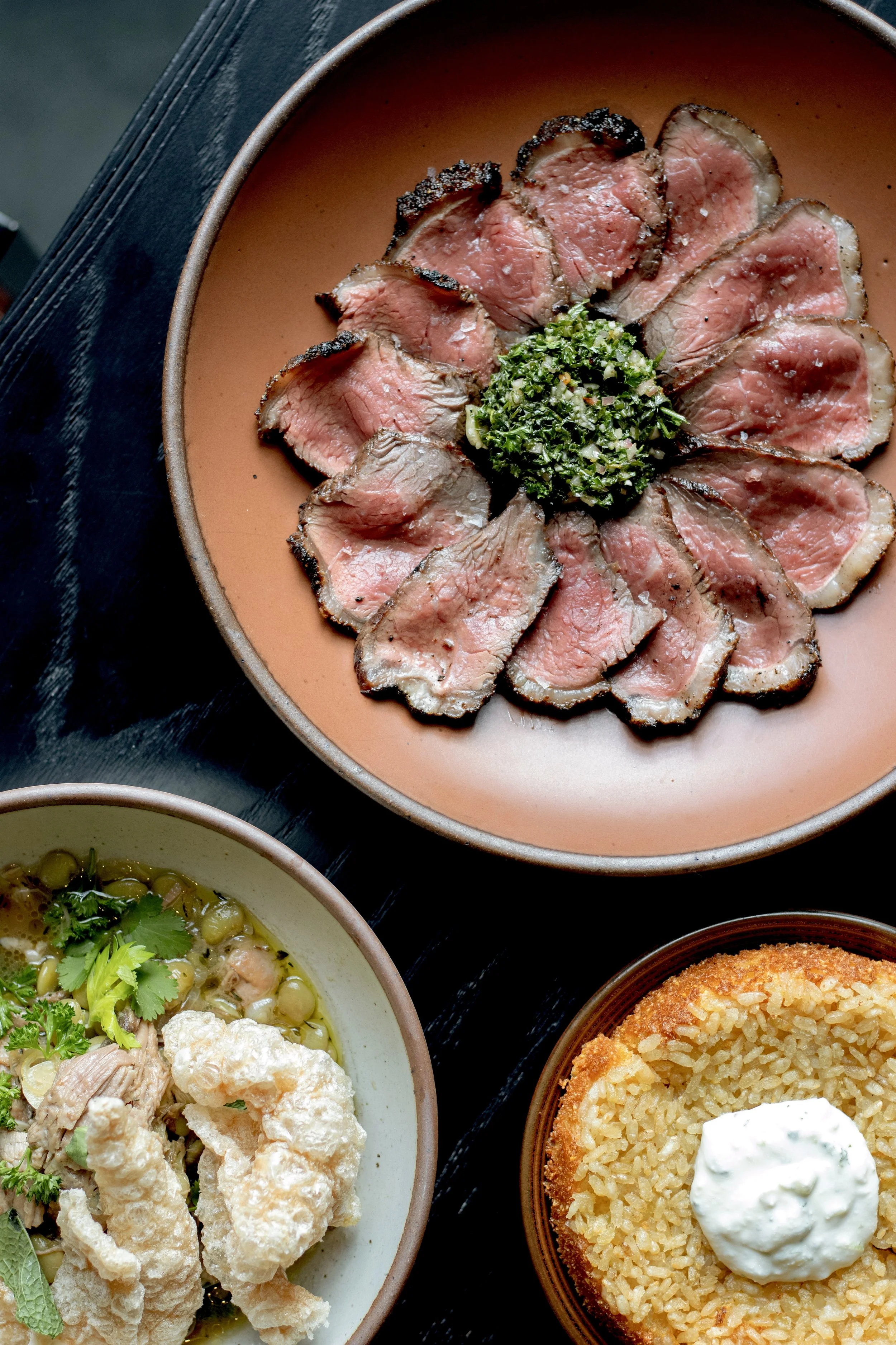 three dishes with meat, dumplings, and cornbread