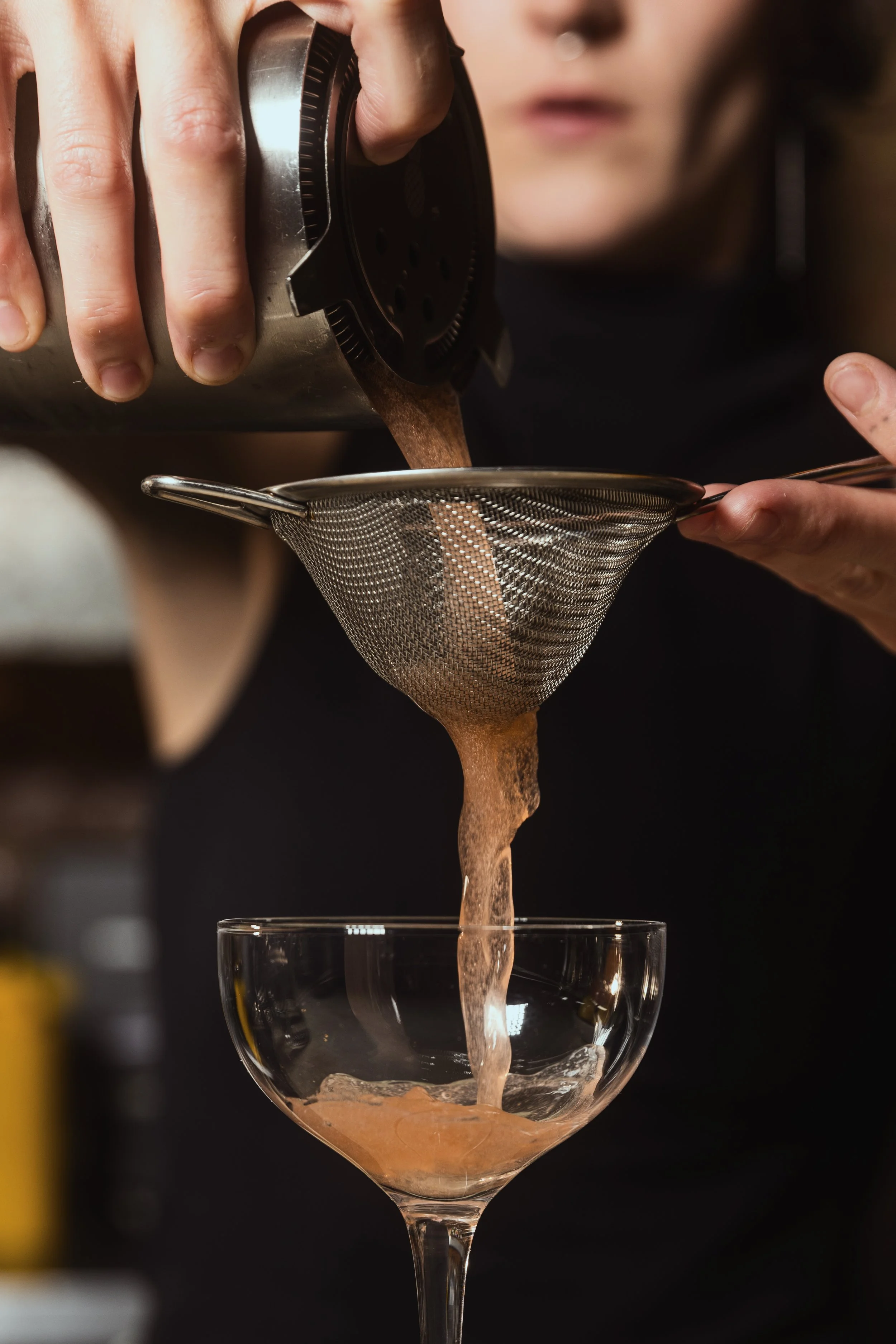 cocktail being strained
