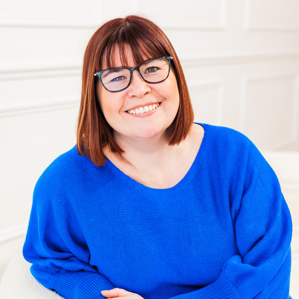 Woman smiling wearing bright blue top