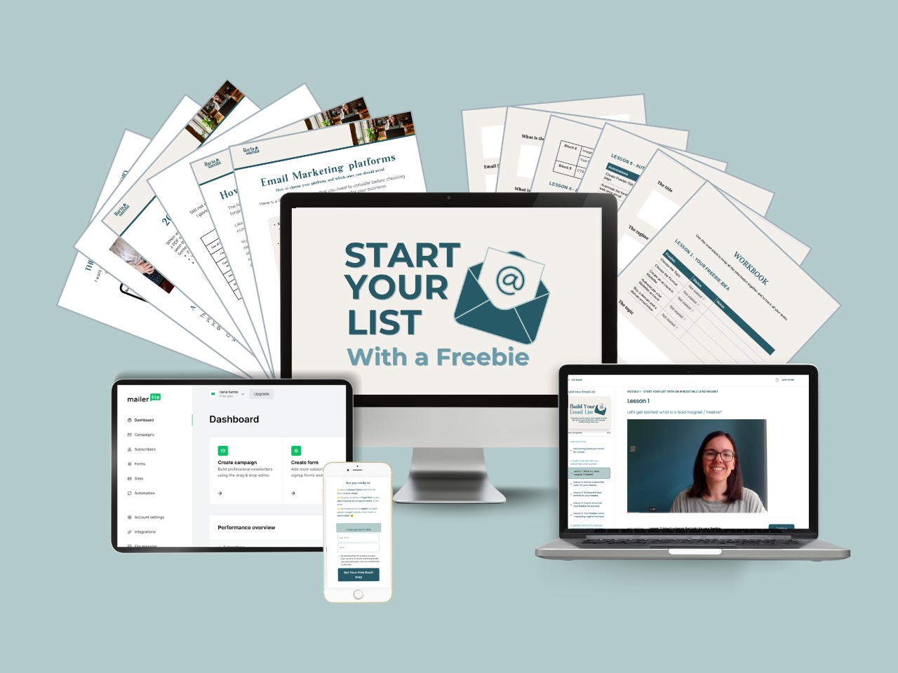 Computer monitor displaying a guide titled "Build Your Email List" with documents and a tablet showing related content in the background.