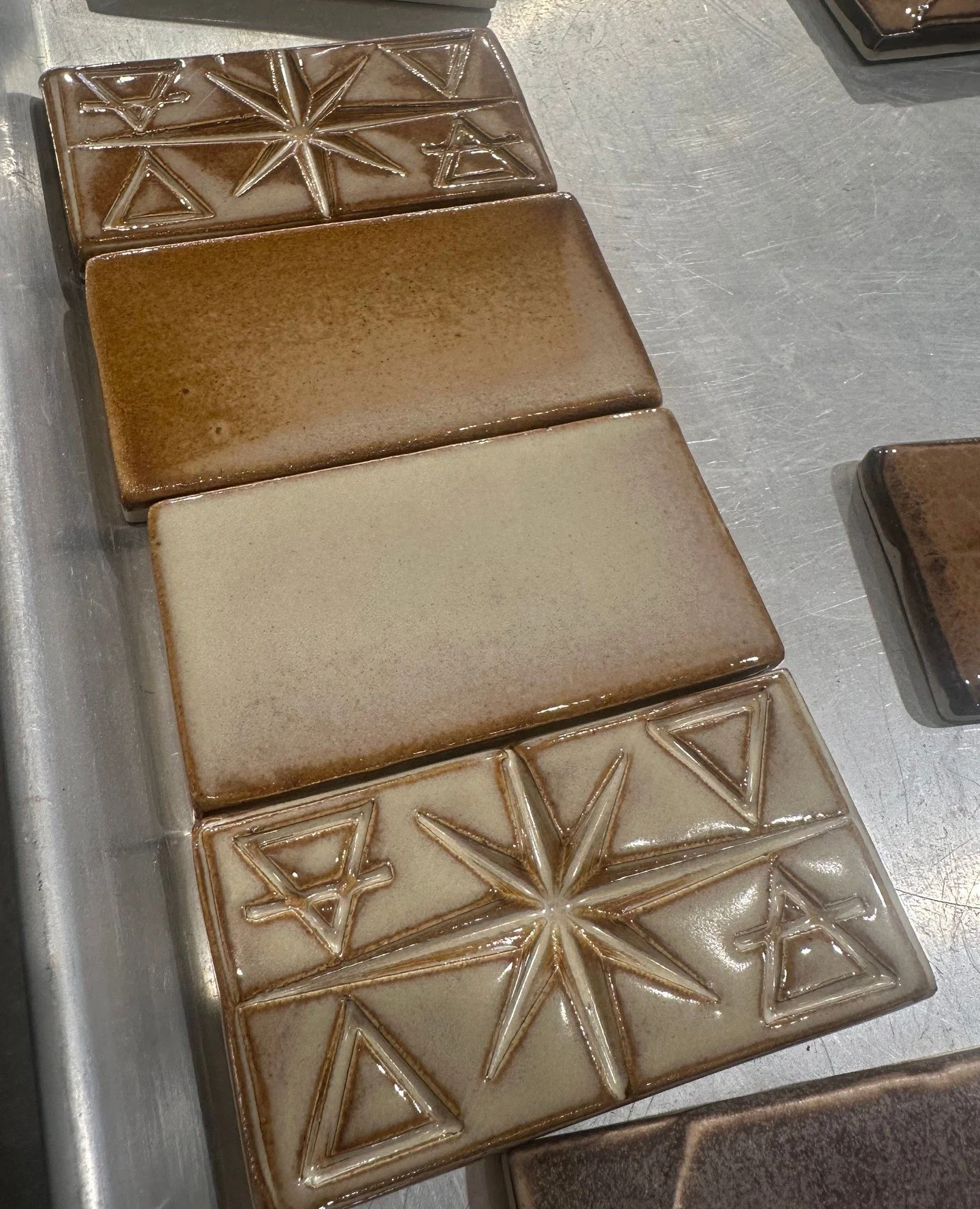 it takes a lot of experimentation to get colors just right for an install - we consider the colors of existing materials in the space, the light from outside, sheen, reflections, whether the edges of the tiles need to be glazed or not around niches, 