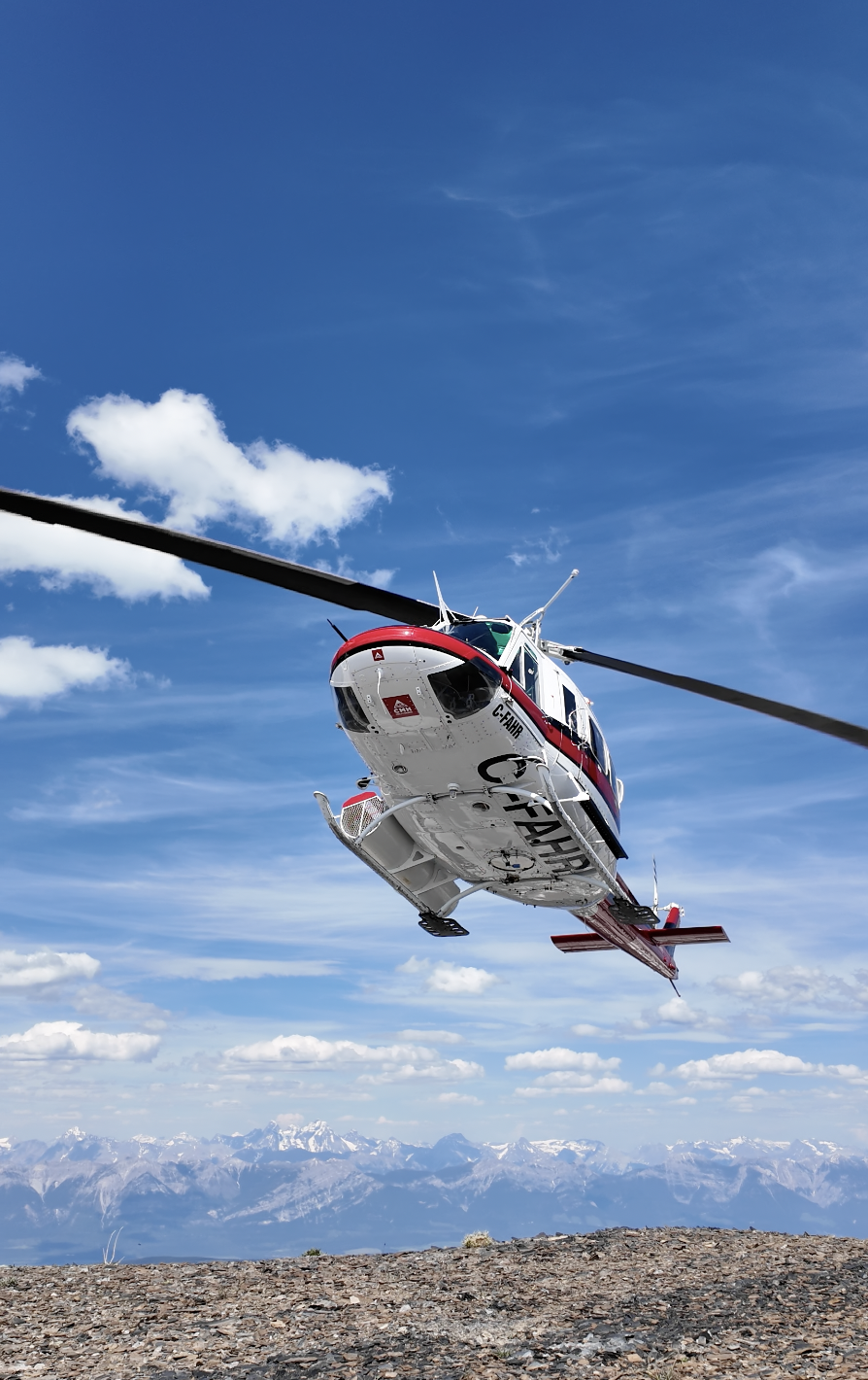 Helicopter dropping hikers into alpine terrain
