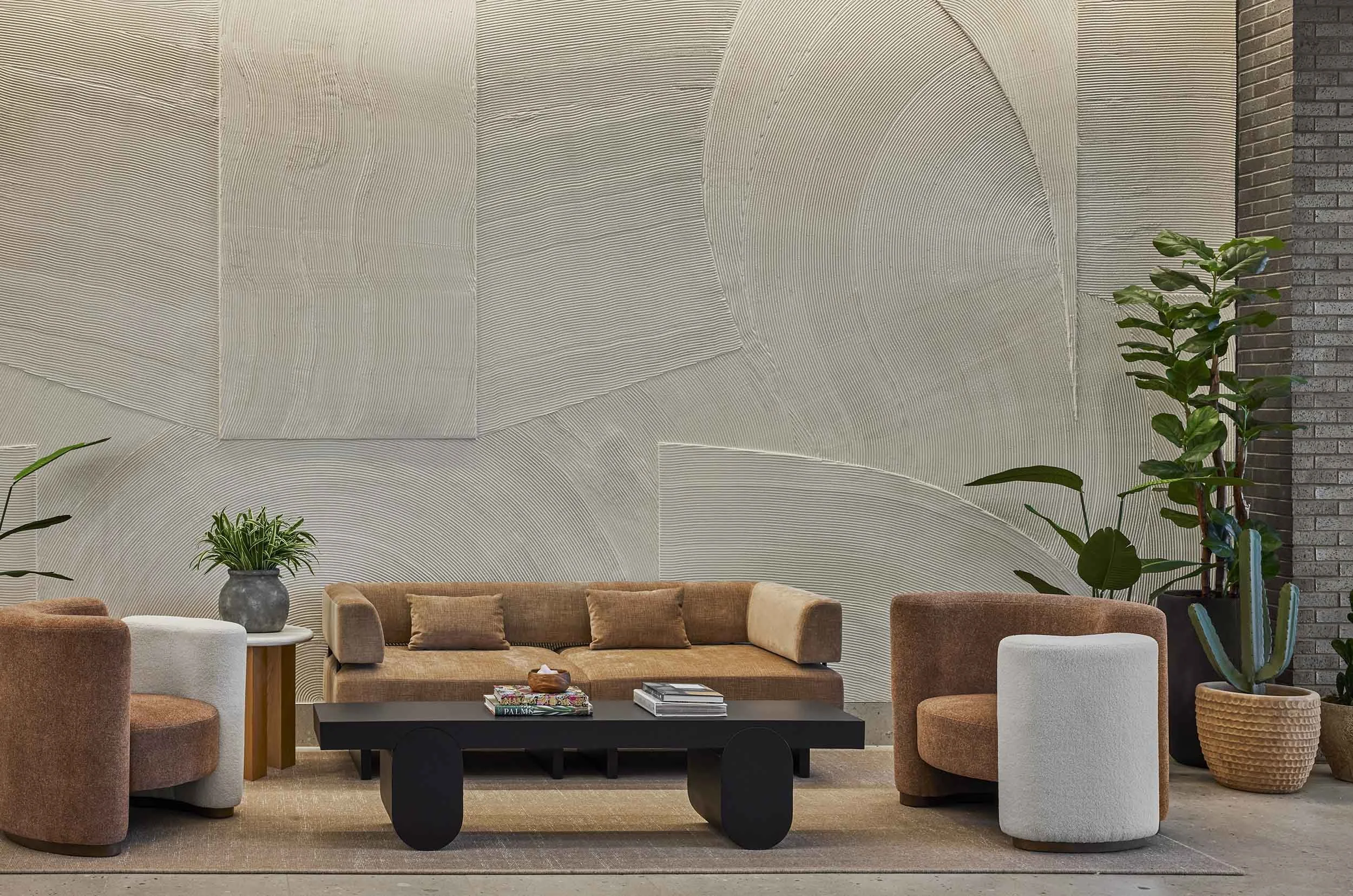 Heavily textured plaster wall, curvaceous lounge furniture