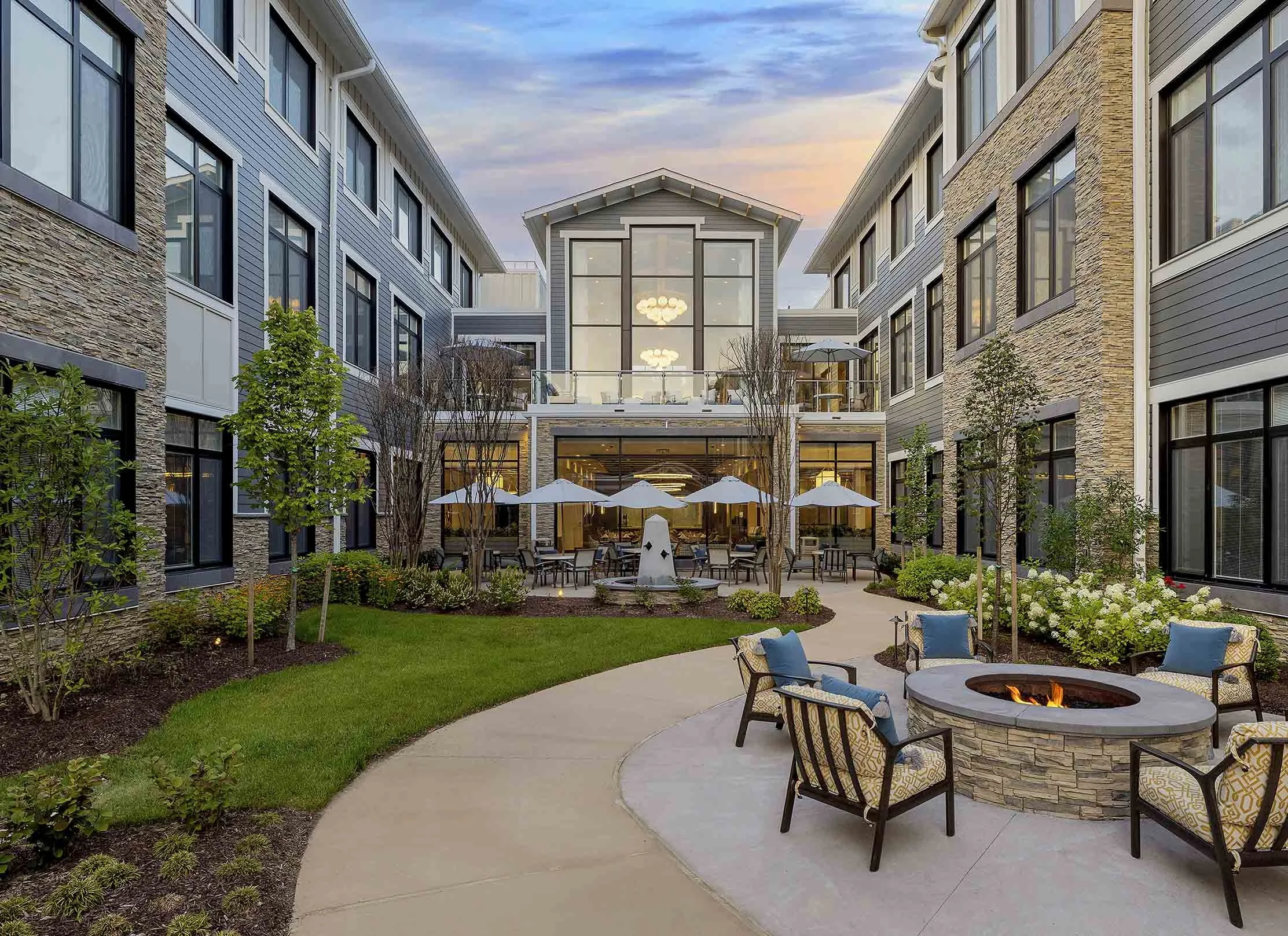 Resident courtyard with firepit and umbrella seating