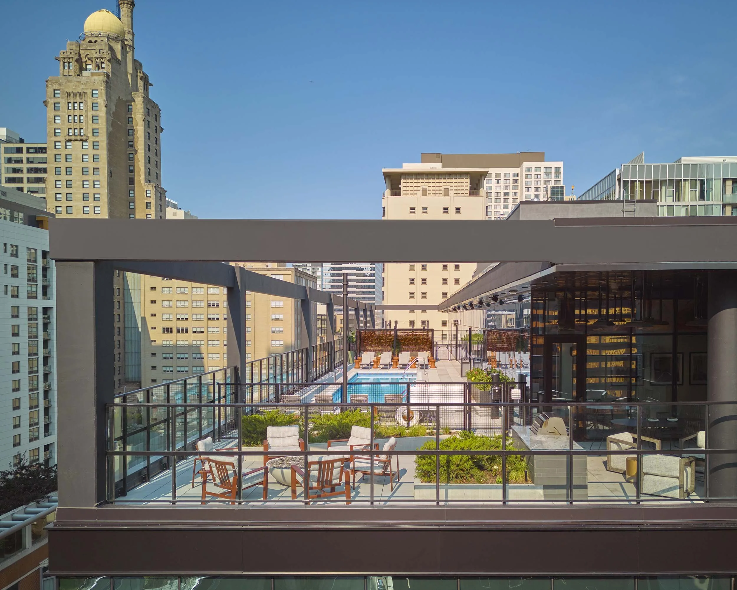 Rooftop amenity layout with pool, firepit, loungers, and grills