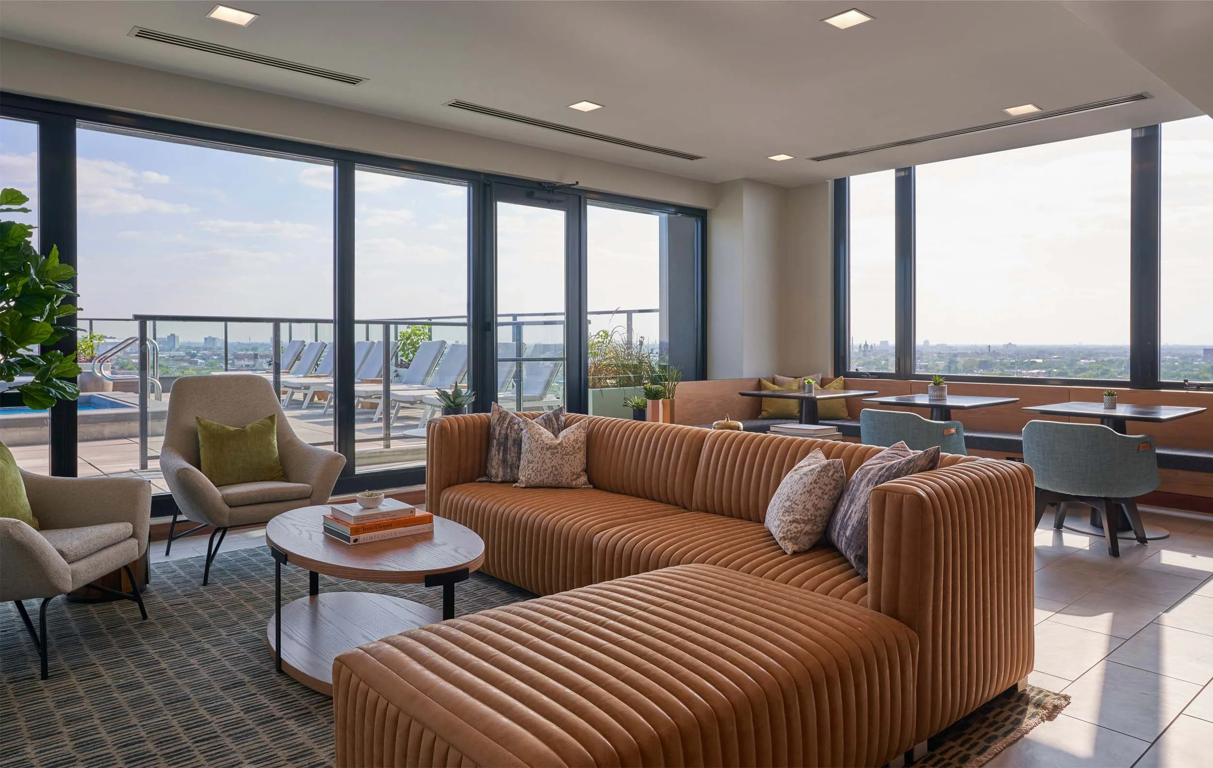 Amenity lounge with vertically tufted leather sectional.