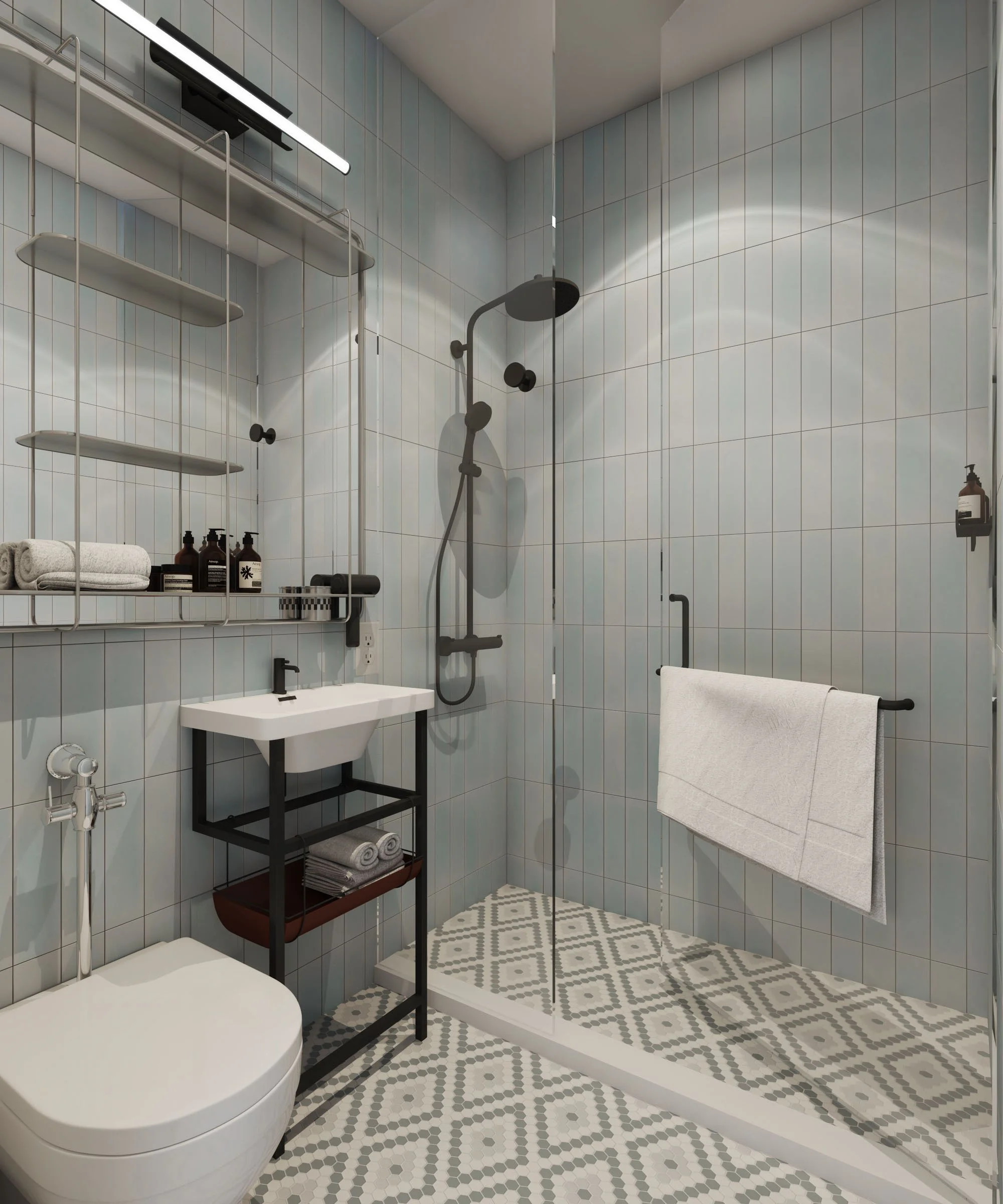 Light blue wall tile with mosaic floor tile in modern industrial hotel bathroom