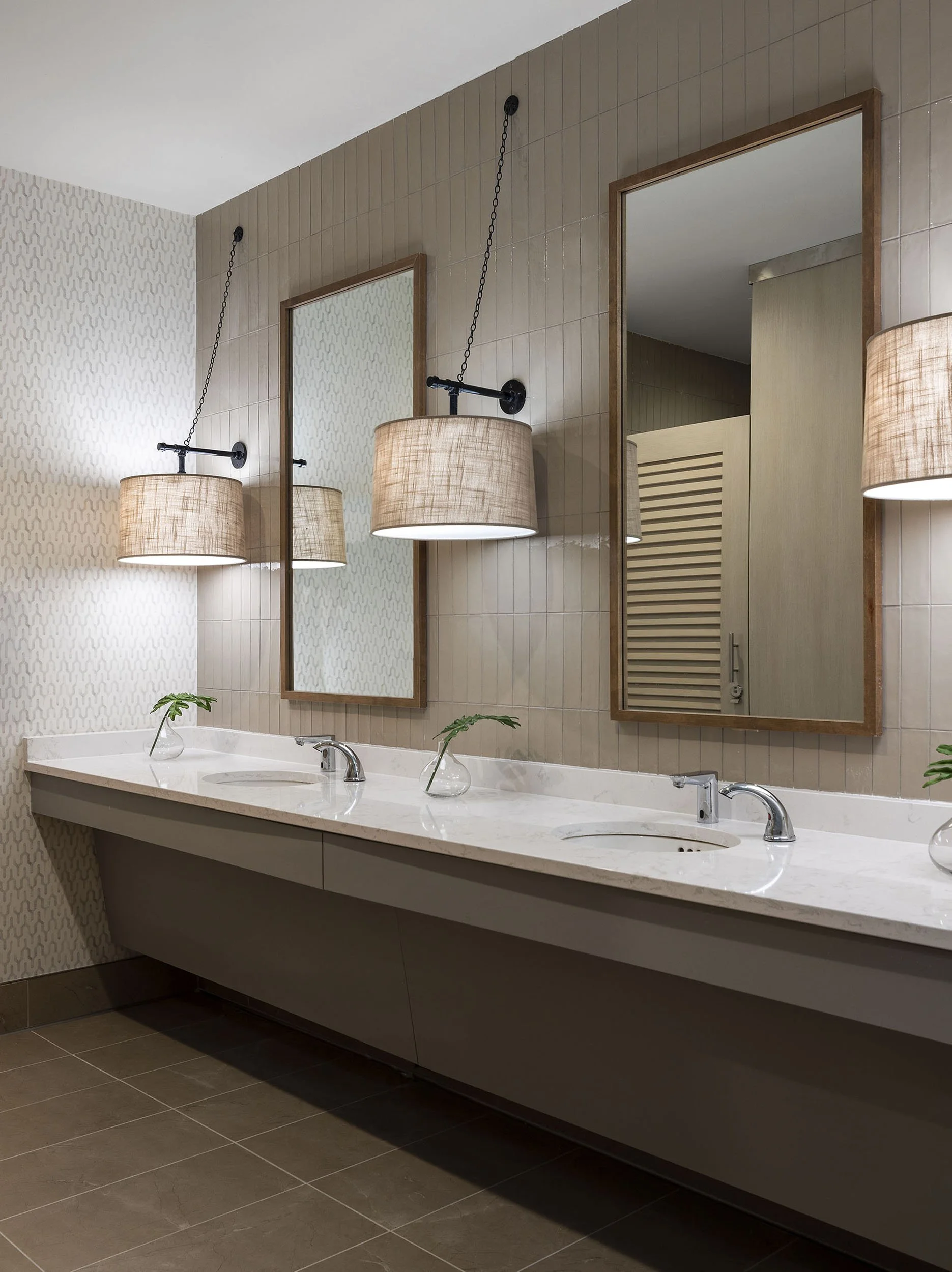 Public restroom with decorative sconces