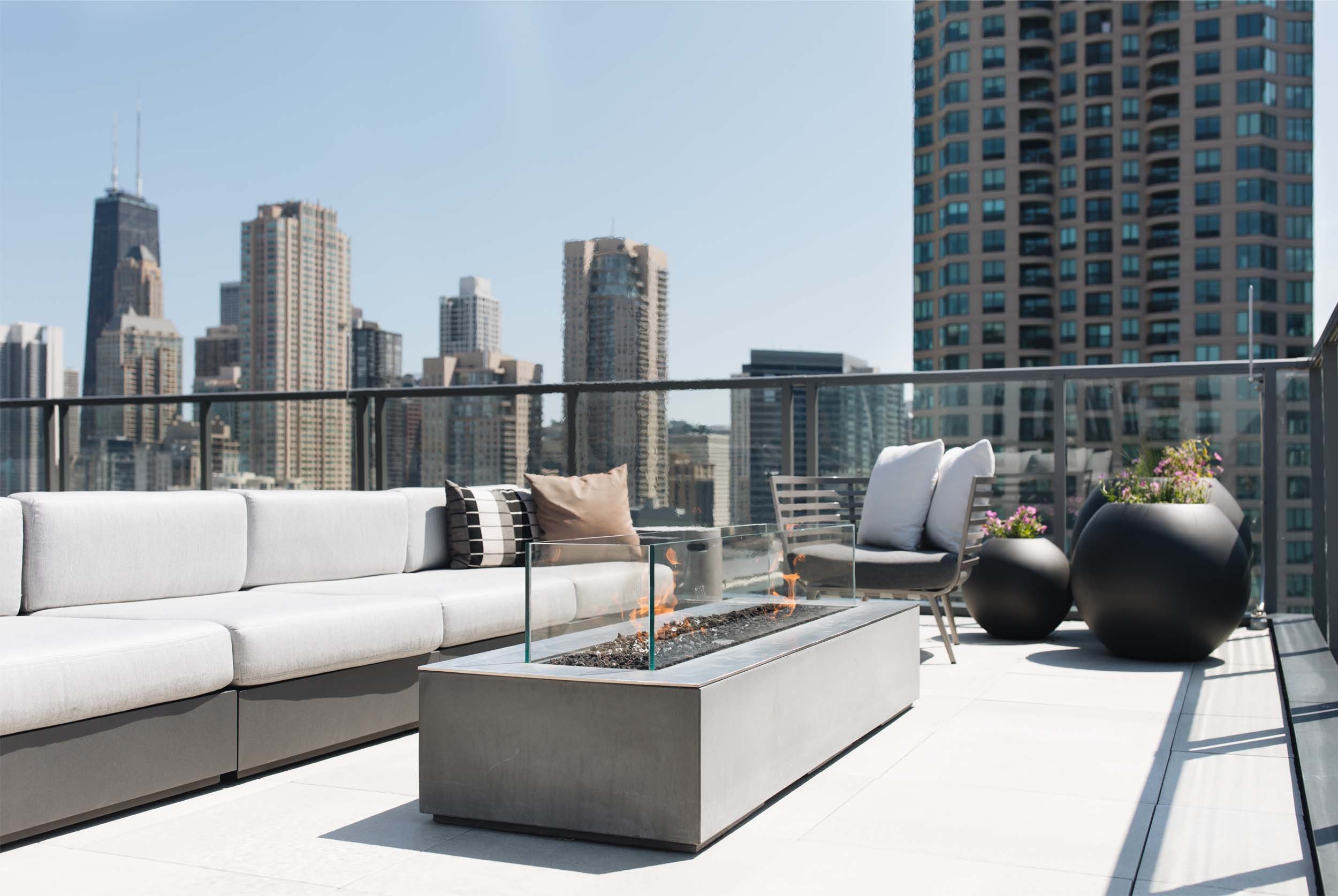 Rooftop fire pit lounge overlooking the Hancock