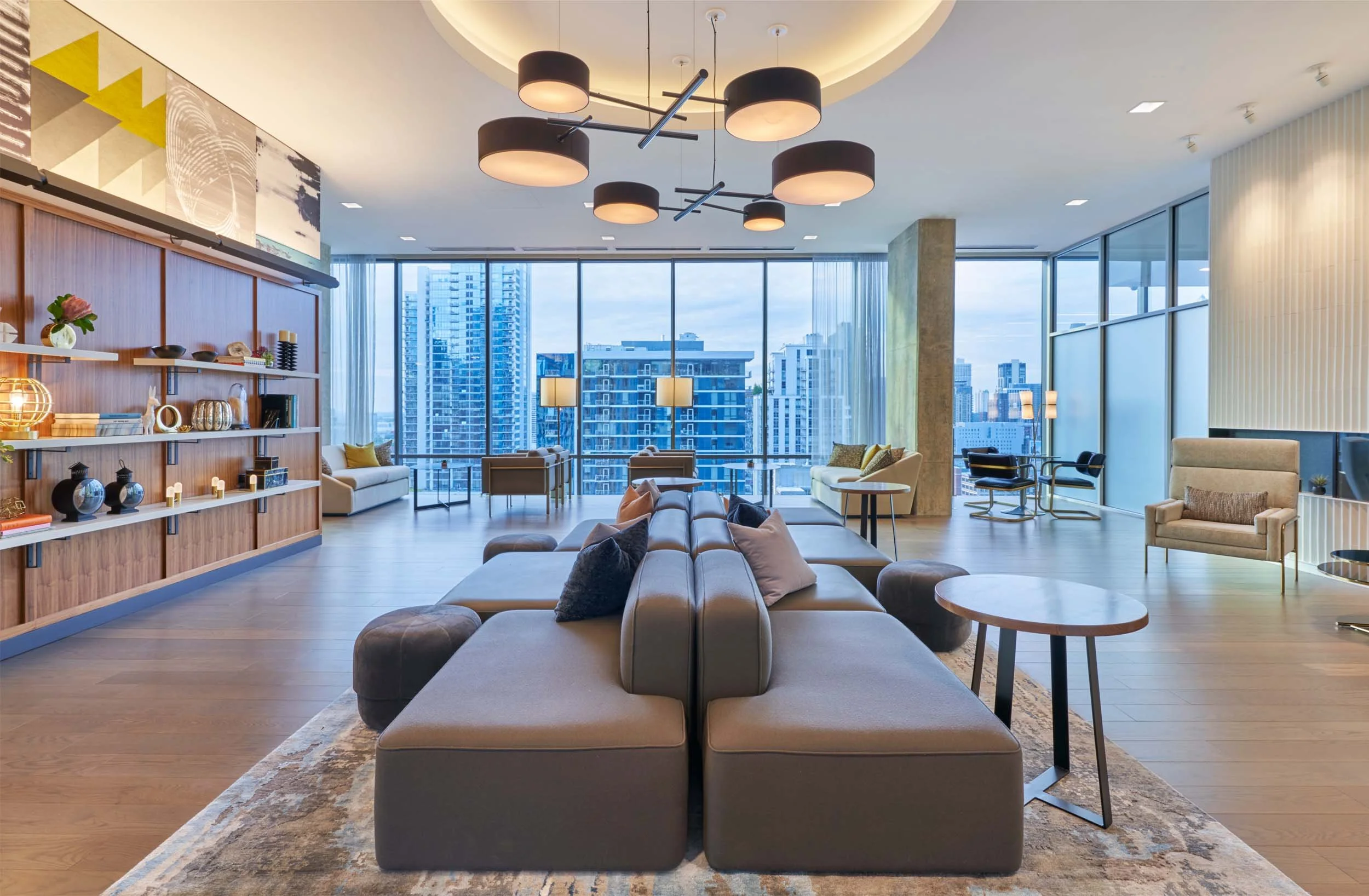 High-rise amenity room with center sectional and skyline views.