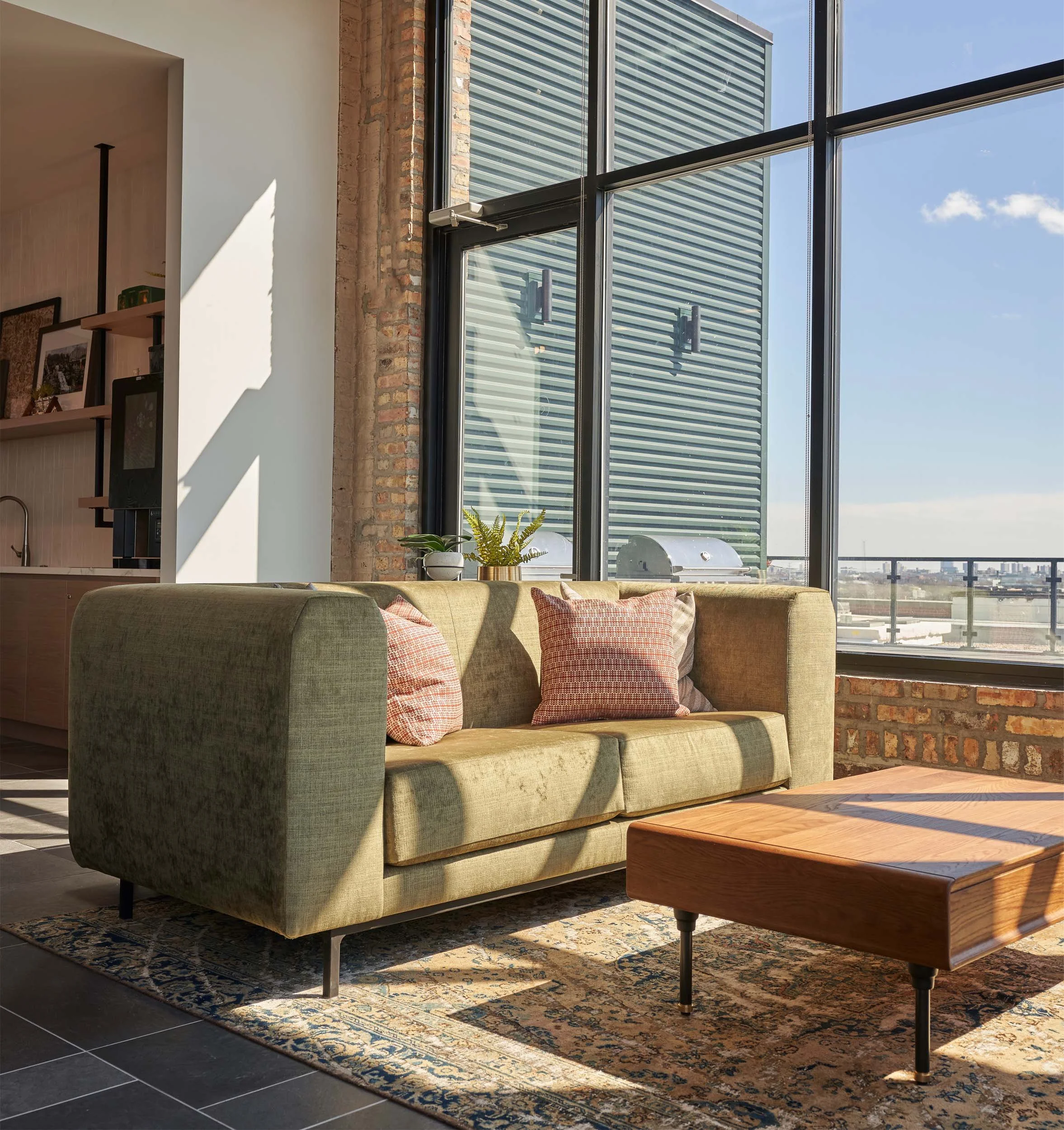 Green velvet sofa with vintage area rug