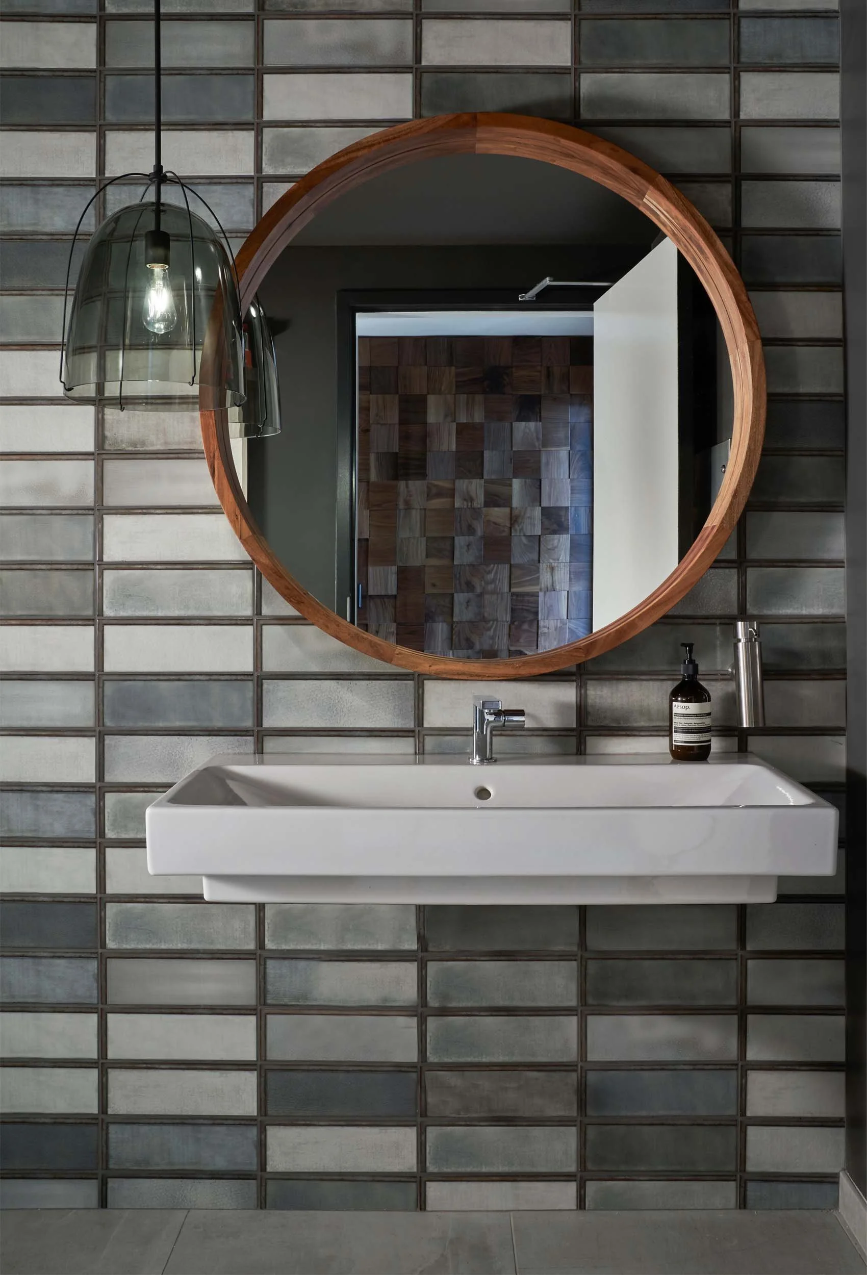 Industrial block tile at restroom vanity.