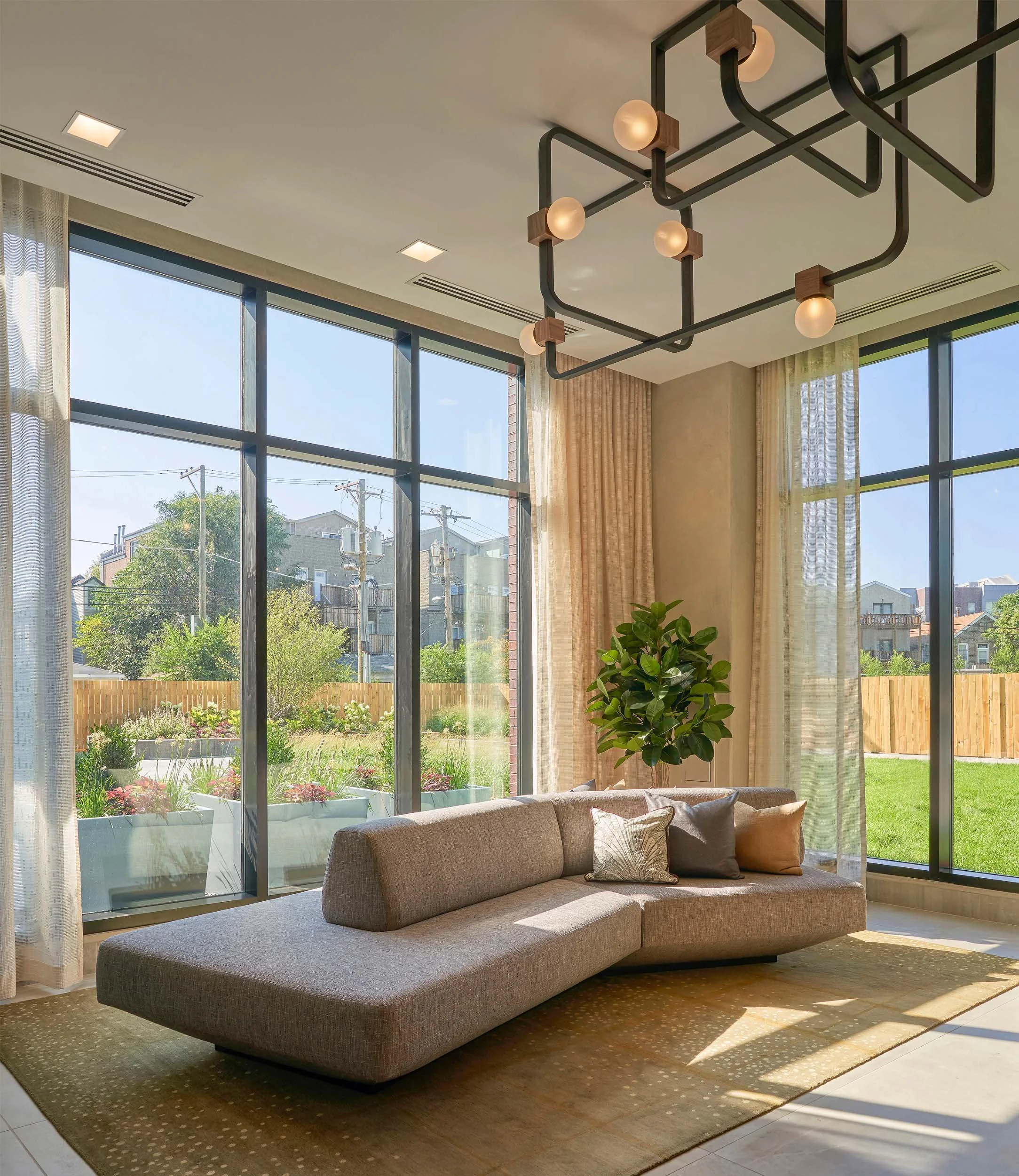 Sunny lobby, custom sectional, interior greenery..