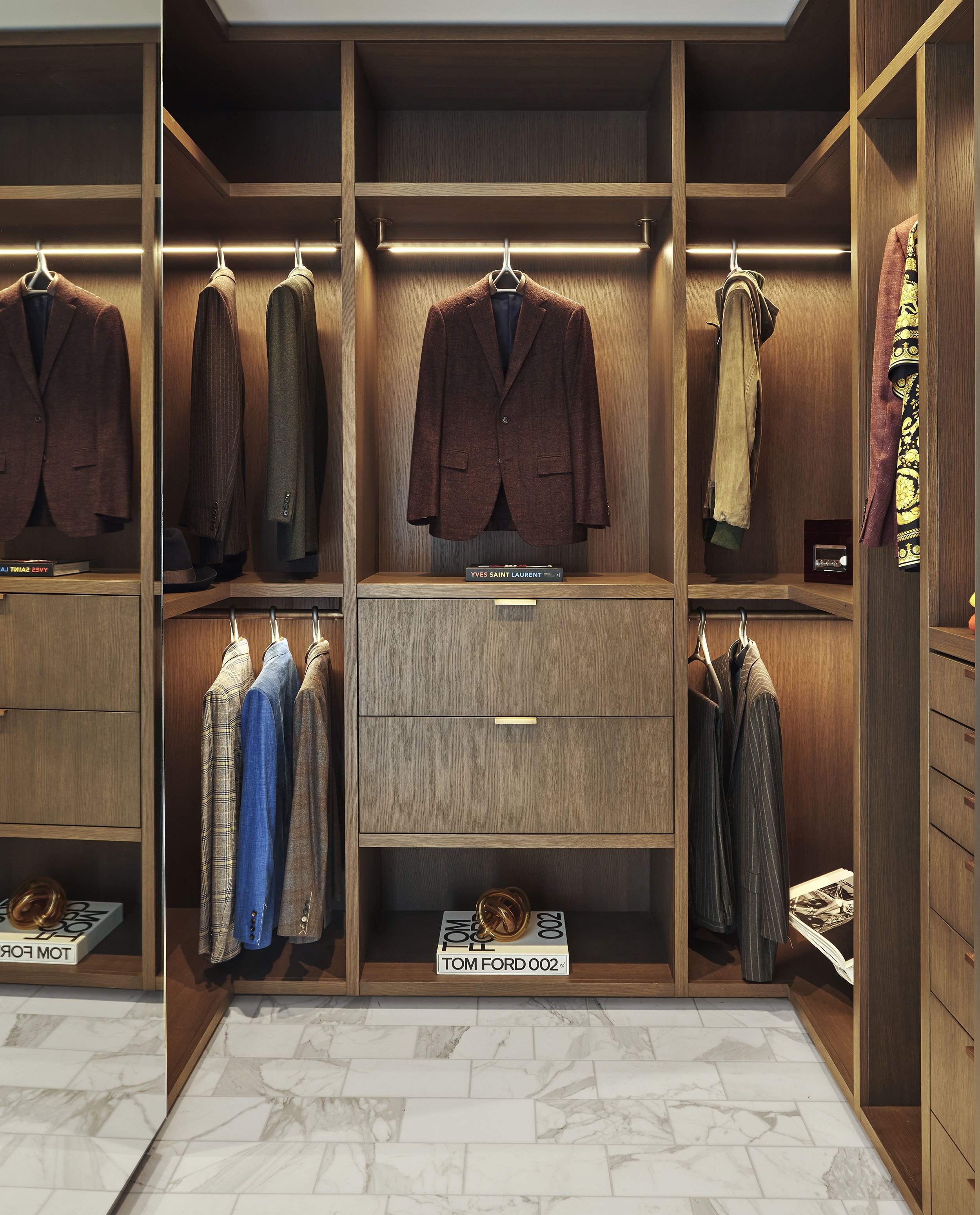 Bespoke closet with lit rods and Lou Hansell hangers