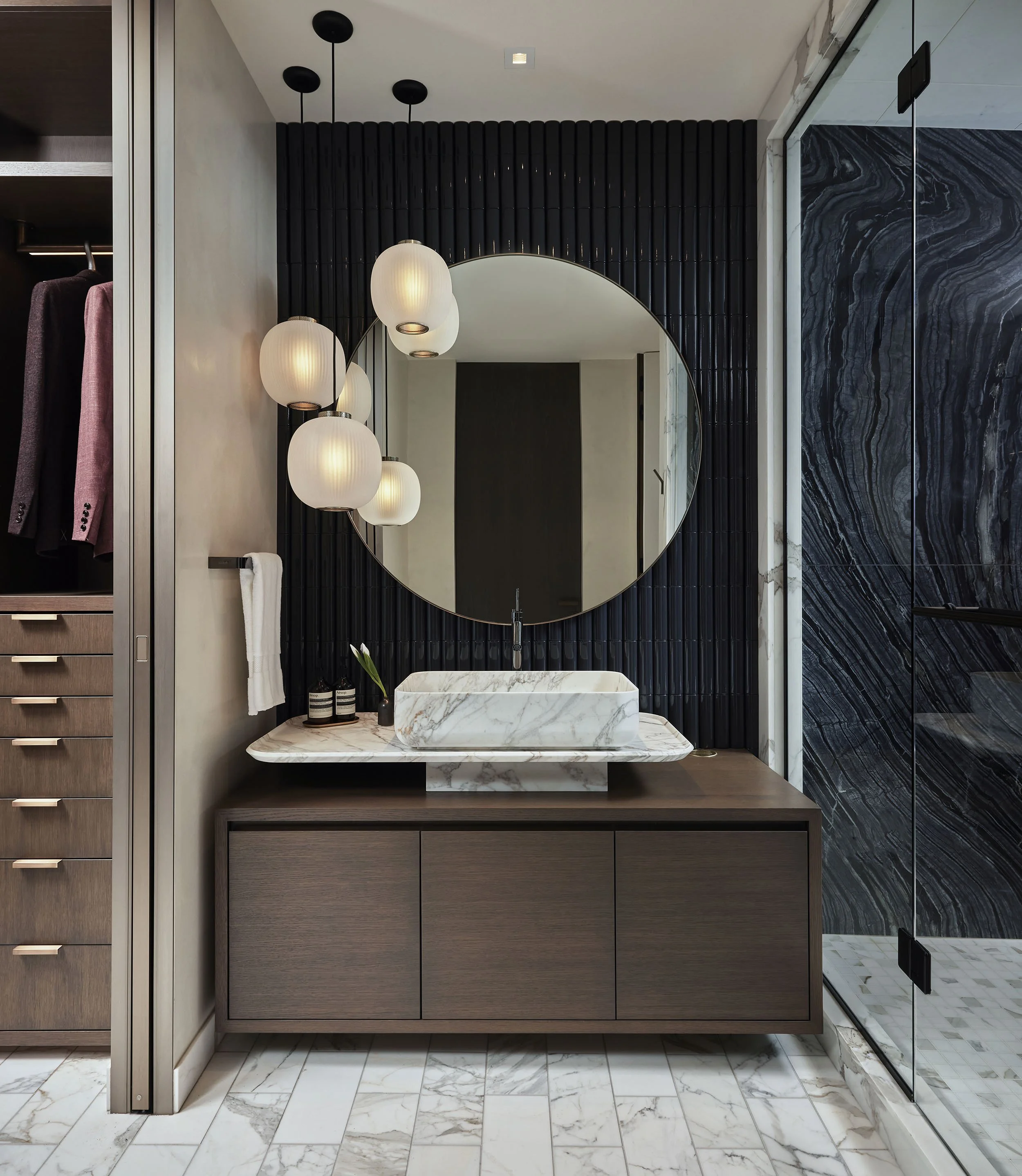 Unique modern vanity with dimensional tile and marble shower, high contrast