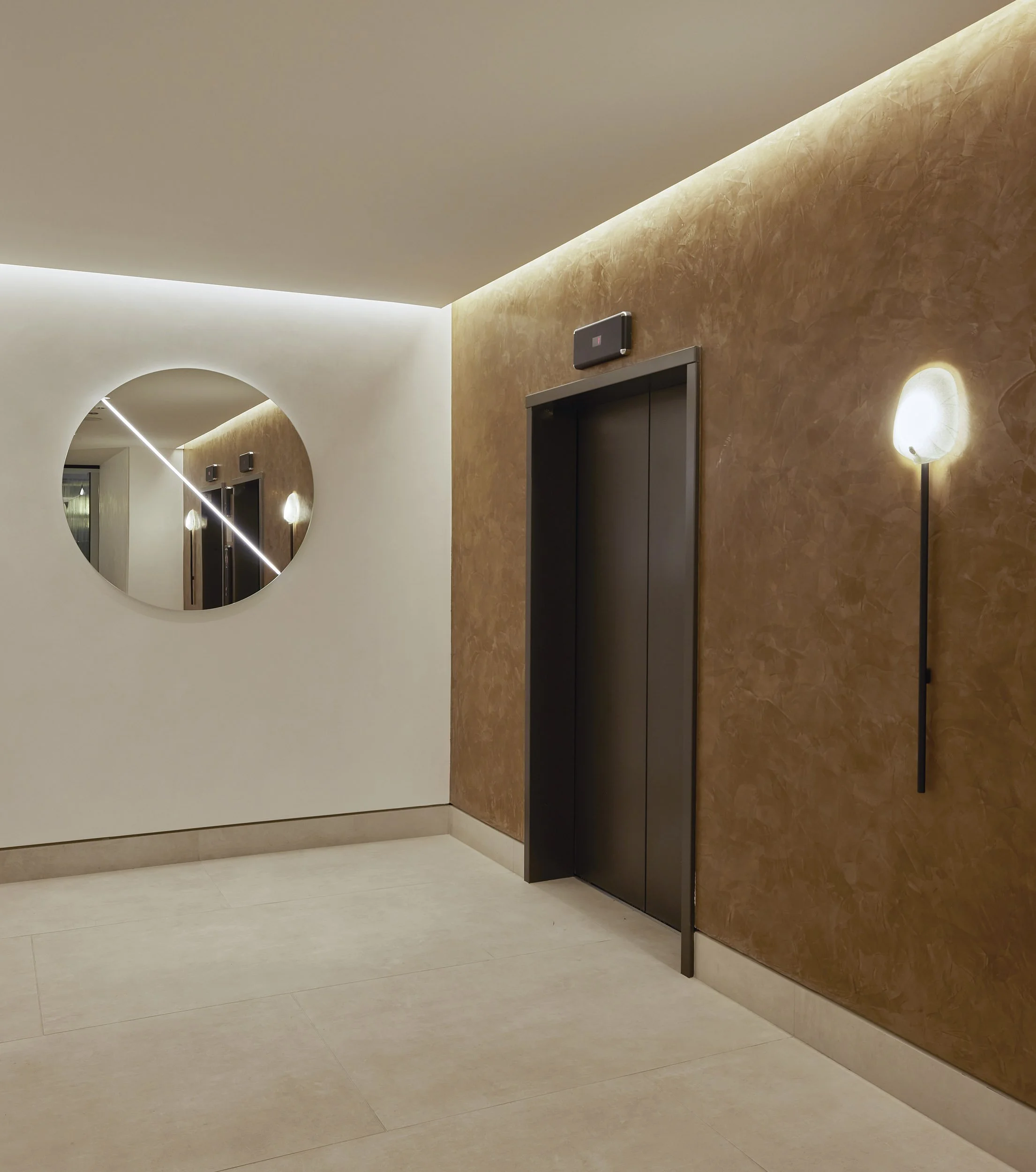 Residential elevator lobby with bronze plaster wall