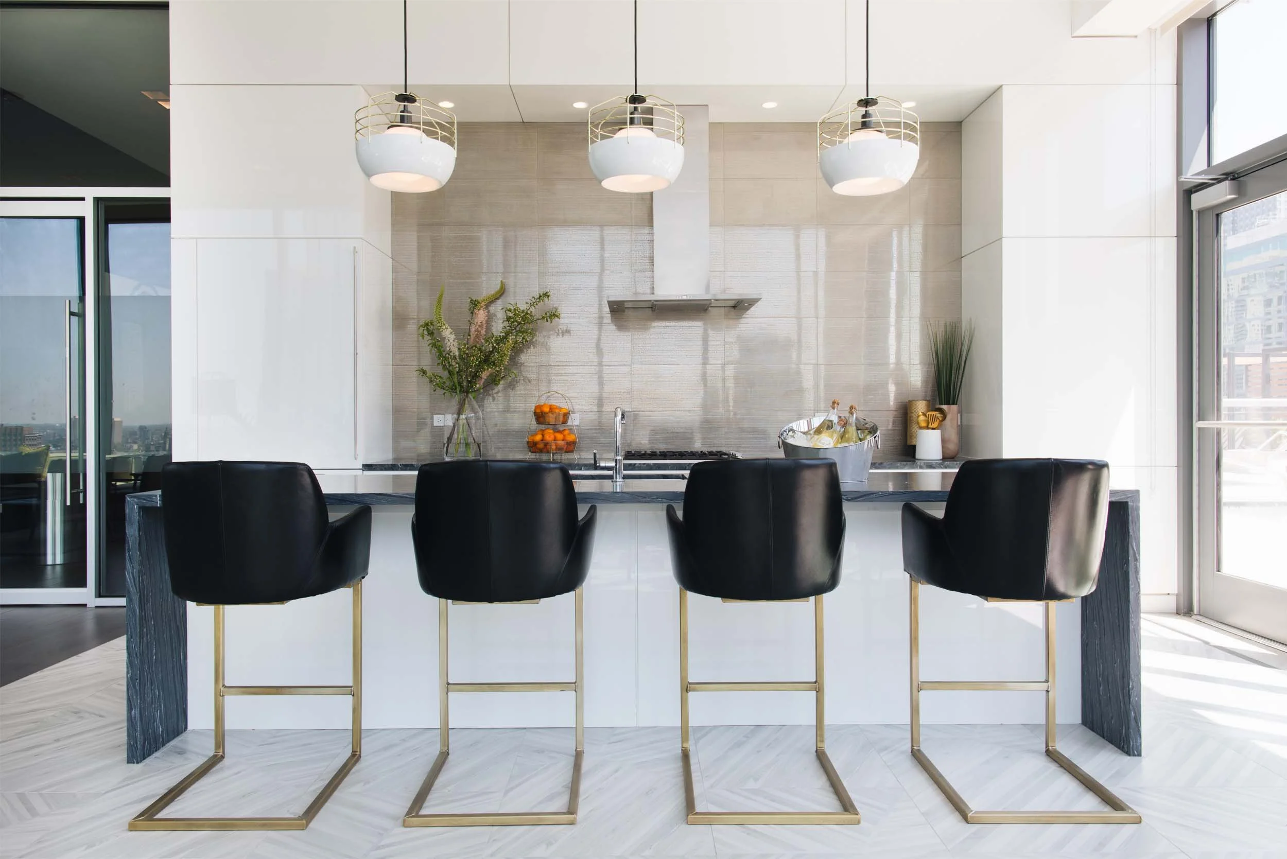 Modern white kitchen with dark stone waterfall island