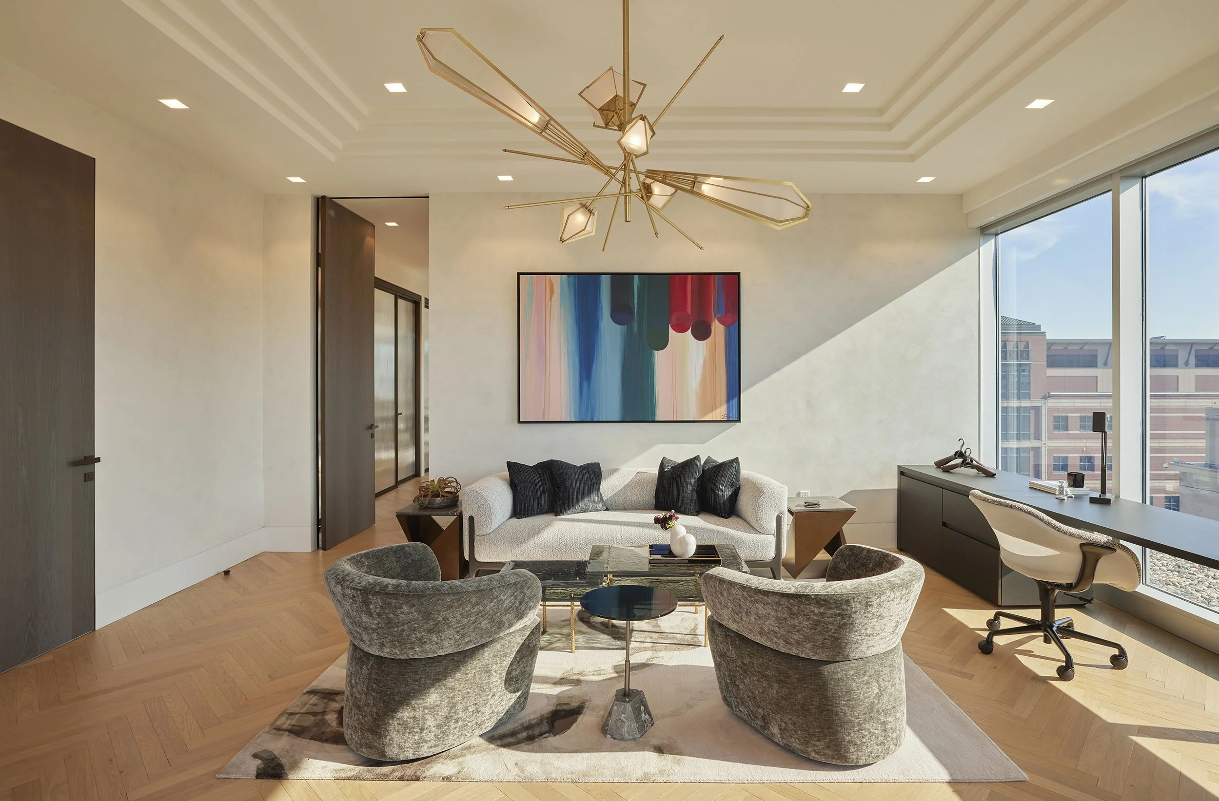 Owner's office with plush lounge and statement chandelier