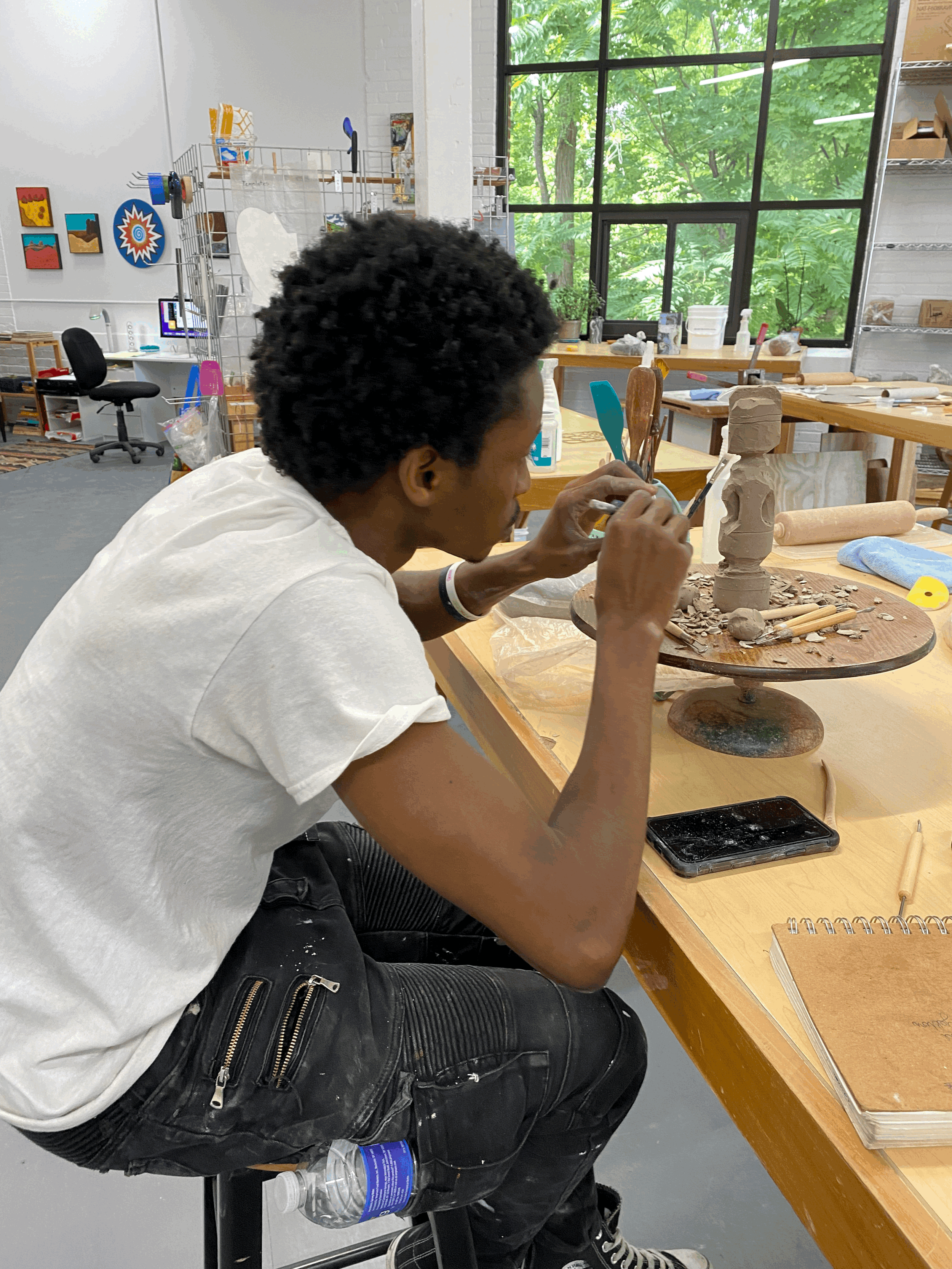 Mohamed hand-building with clay