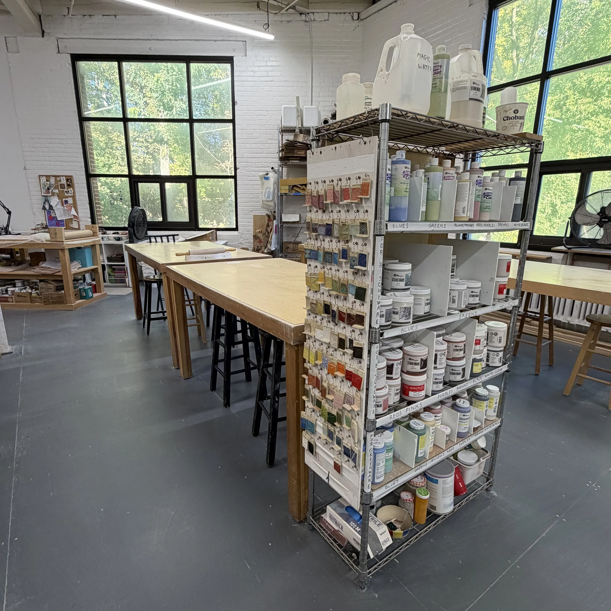 studio photo with glazes and sample tiles