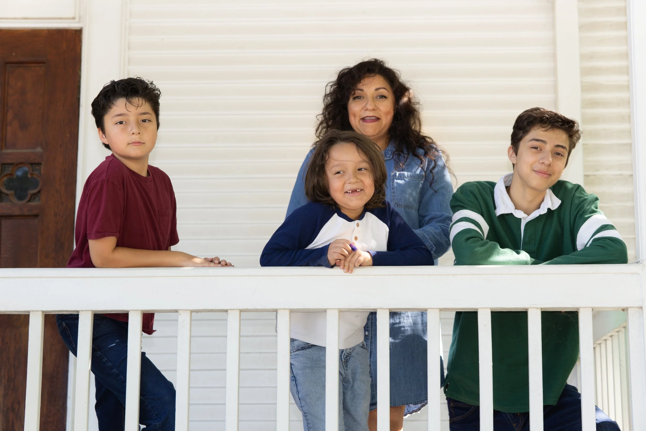 Family portrait on historic porch at Chestnut Square in McKinney TX