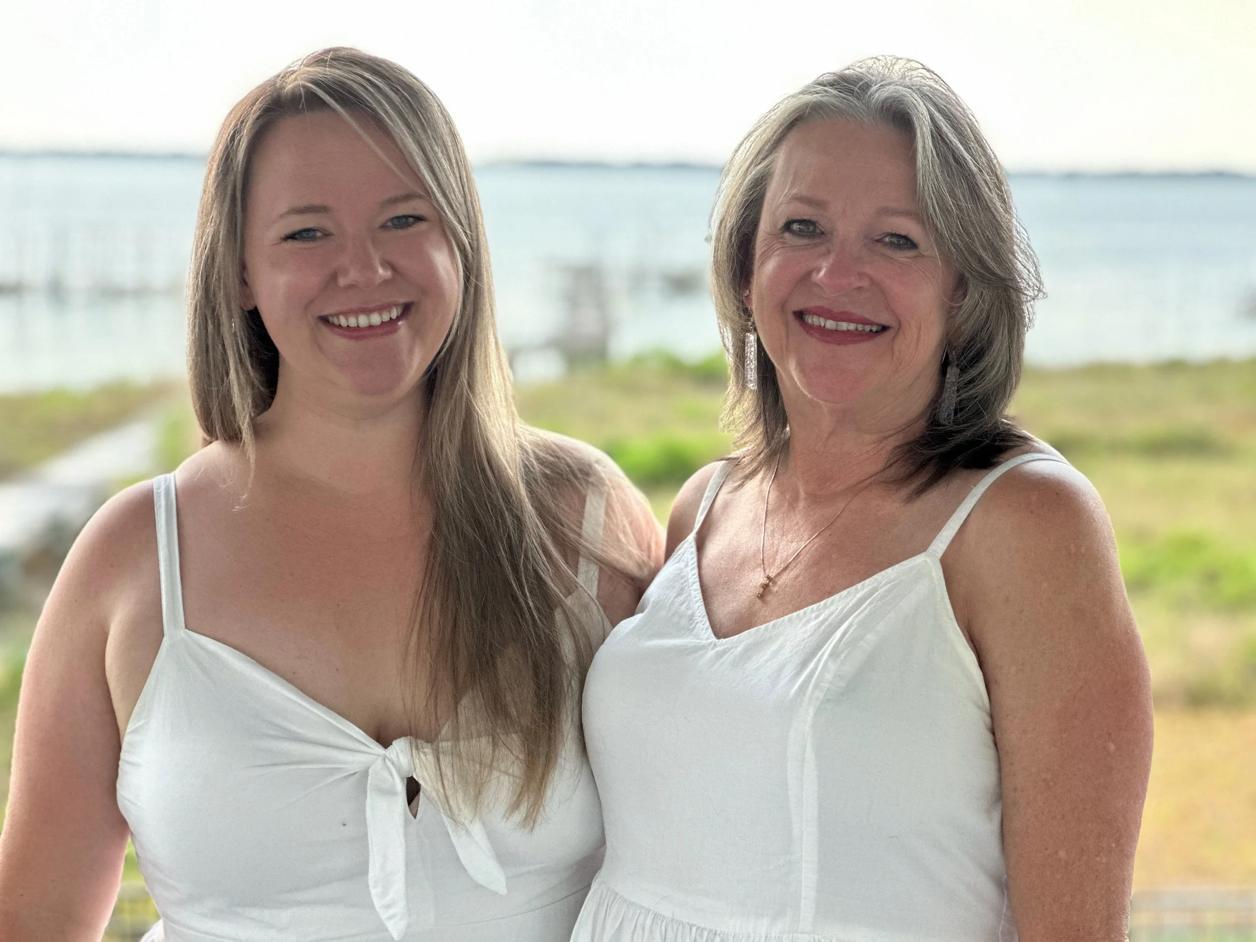 Portrait of two women smiling by the bay