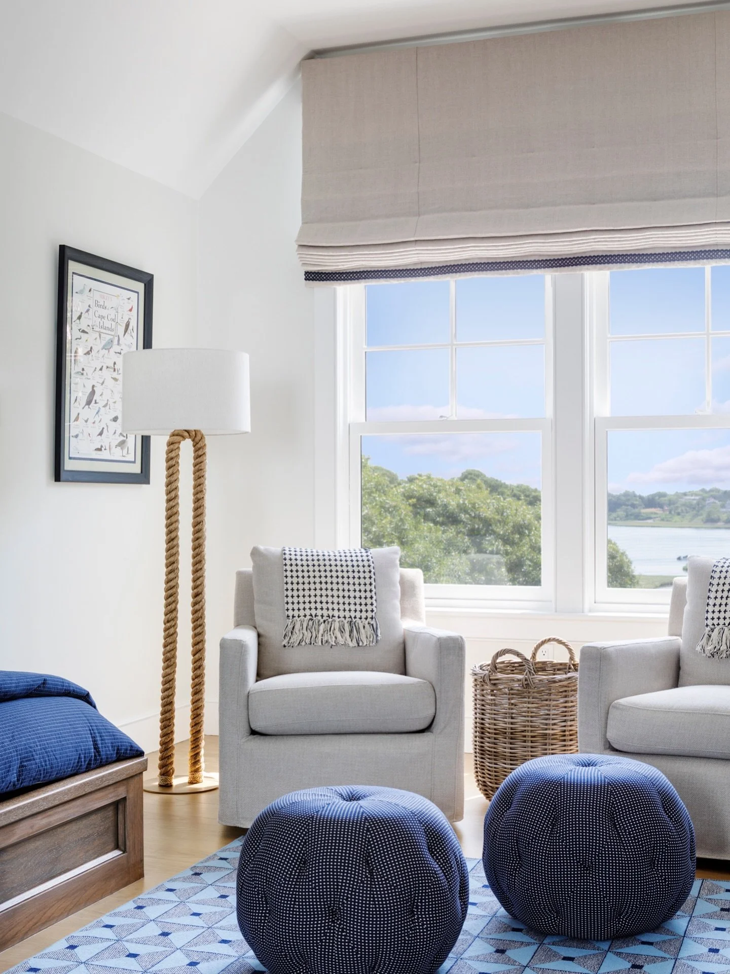Soft blue accents and beachy finishes create a casual and cozy feel in this Cape Cod home. Playful poofs and accents throughout bring a fun yet refined look. #KennerknechtDesignGroup⁠
⁠
#livingroomdesign #livingroom #interiordesign #beachhousedesign 