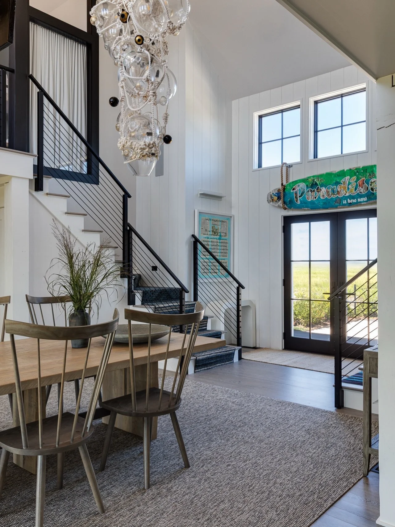 Central to this dining area is a Lindsey Adelman chandelier, gently drawing attention with intricate rope and hand-blown glass orbs. Beautiful handcrafted dining table from O&amp;G Studios welcome guests to gather at this seaside escape. ⁠⁠#Kennerkne