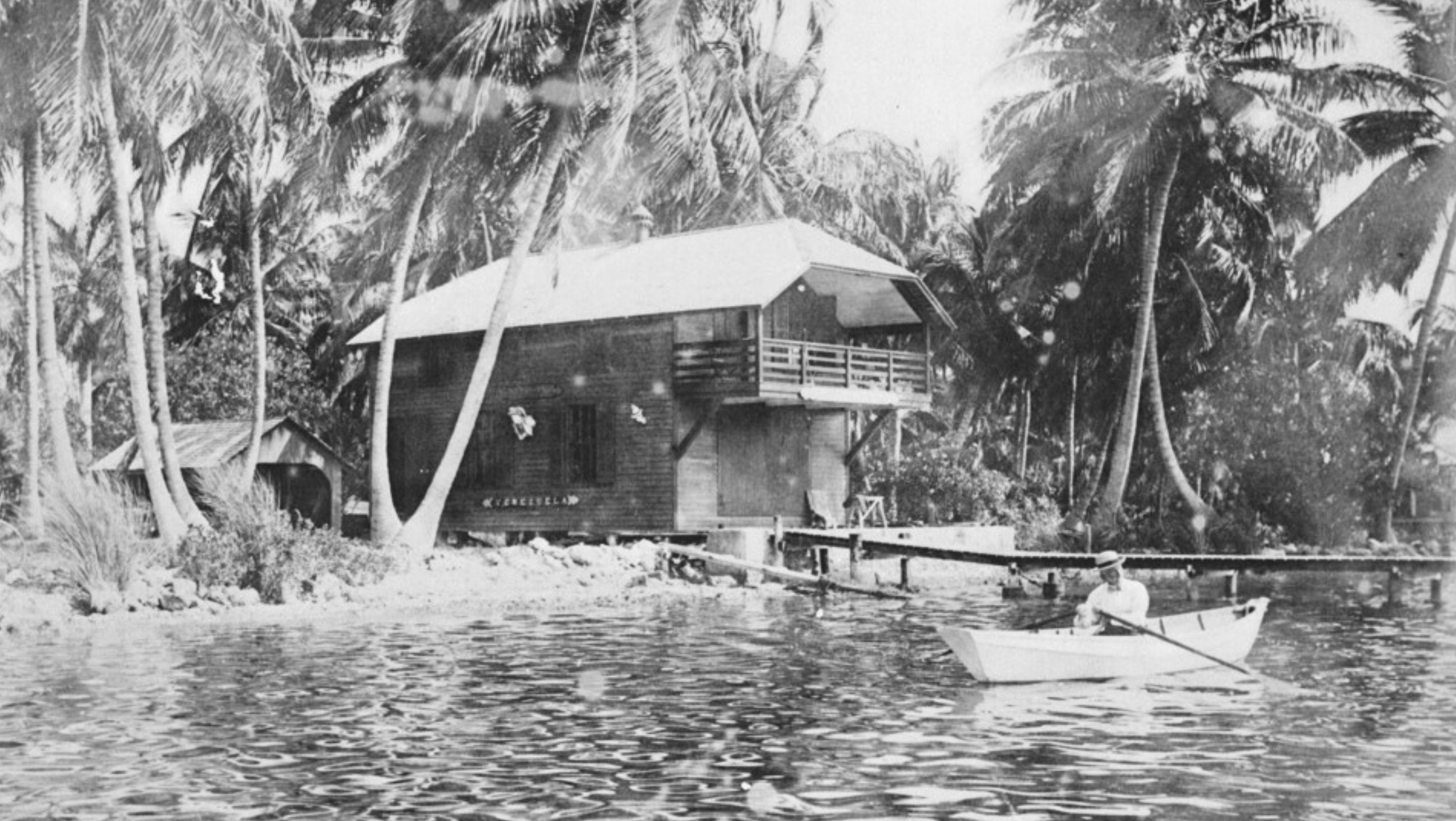 The Barnacle's Boathouse and Munroe rowing on the bay