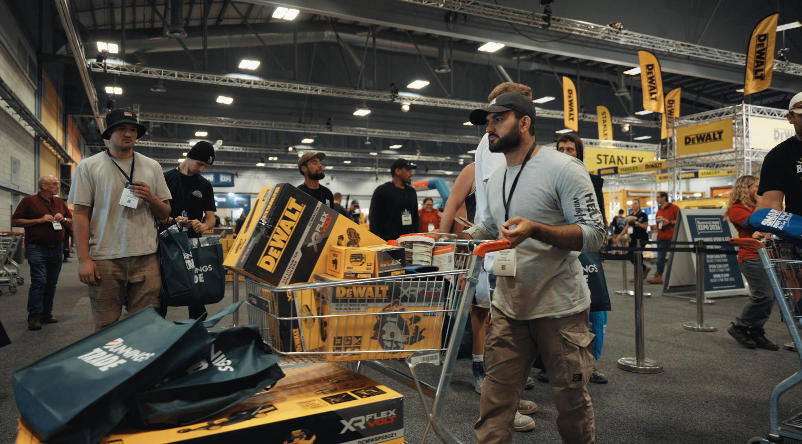 A shopper browsing DeWalt power tools on the trade floor at the Bunnings Trade Expo