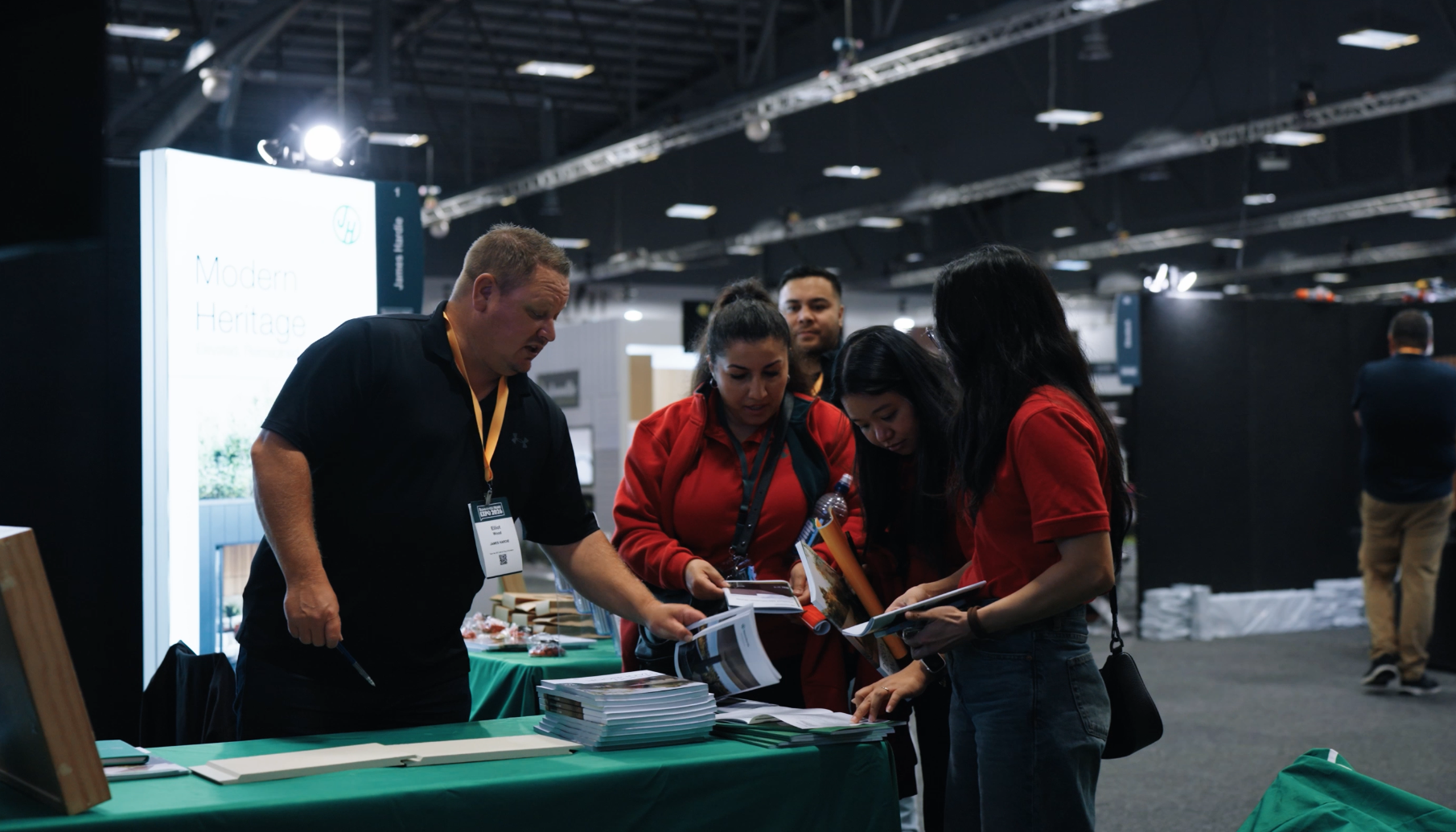 Bunnings staff reviewing printed materials at a table during the Bunnings Trade Expo