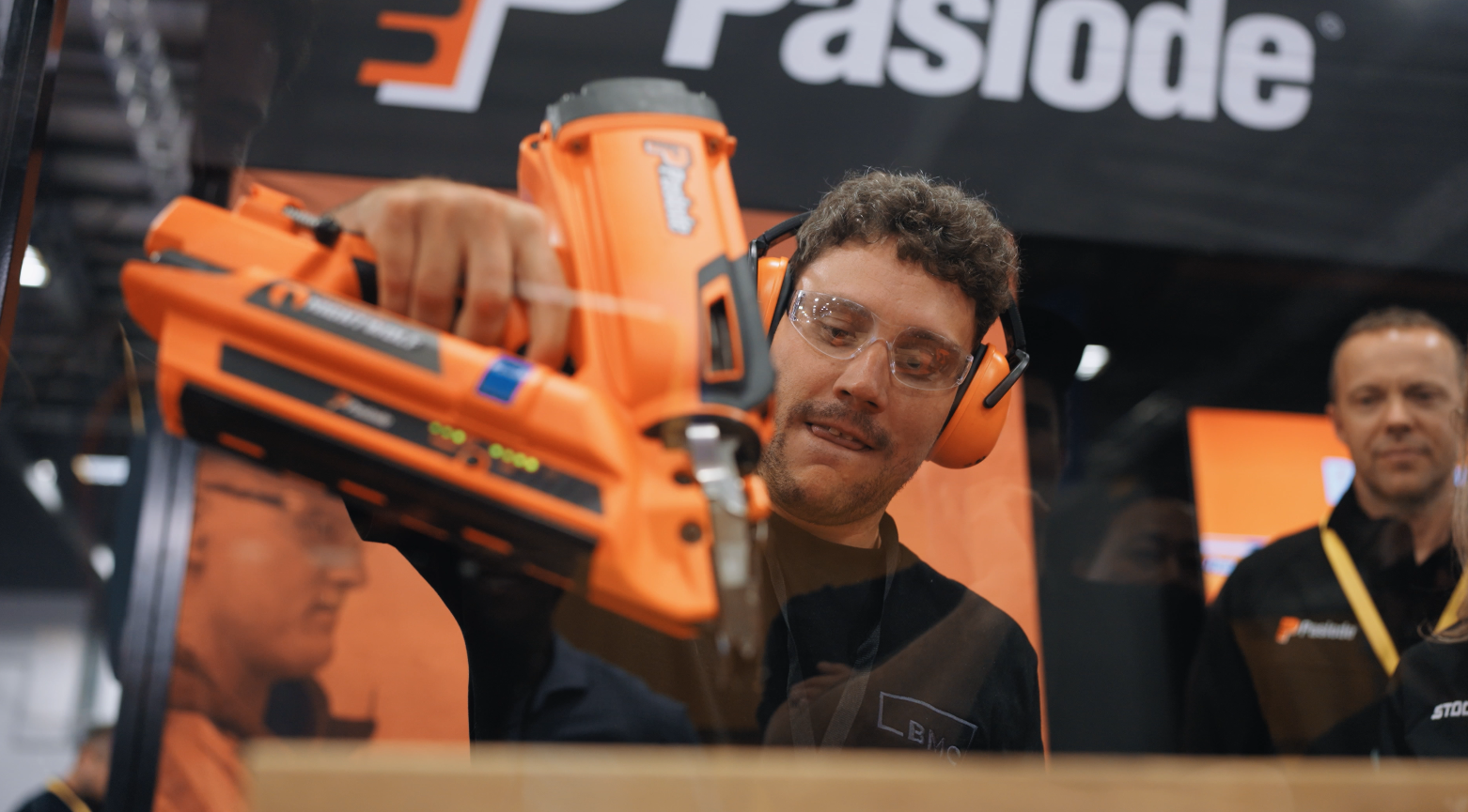 A supplier demonstrating a Paslode nail gun to attendees at the Bunnings Trade Expo