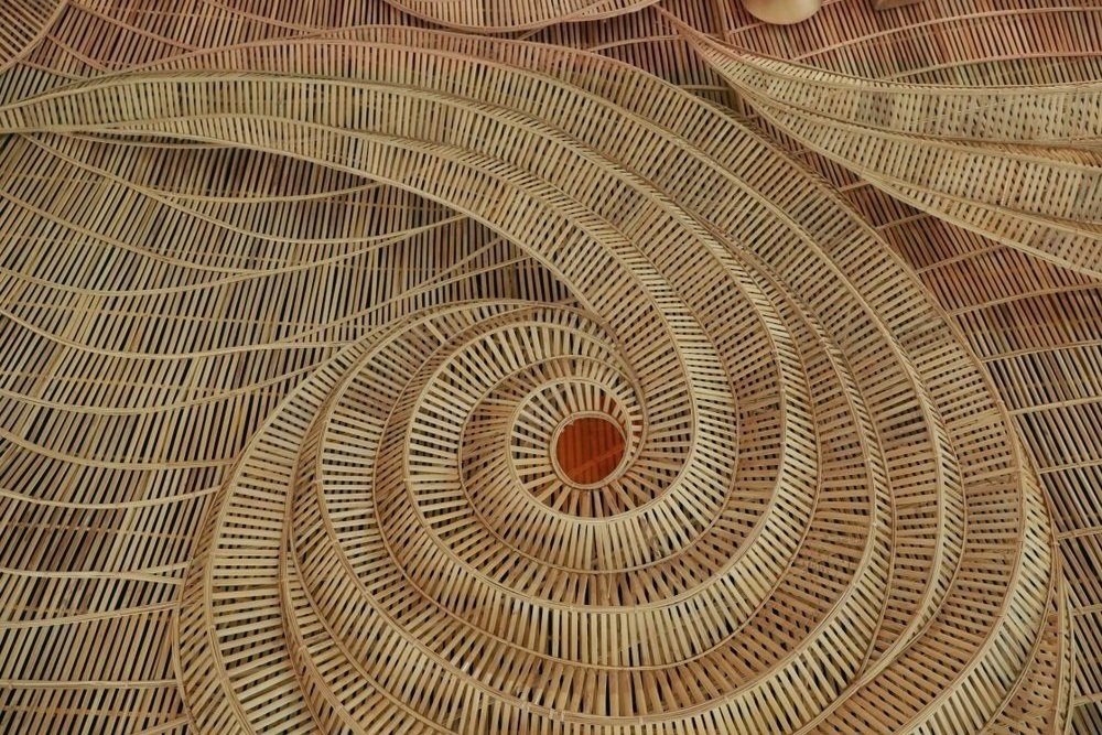 Circular woven artwork with intricate natural fibre patterning