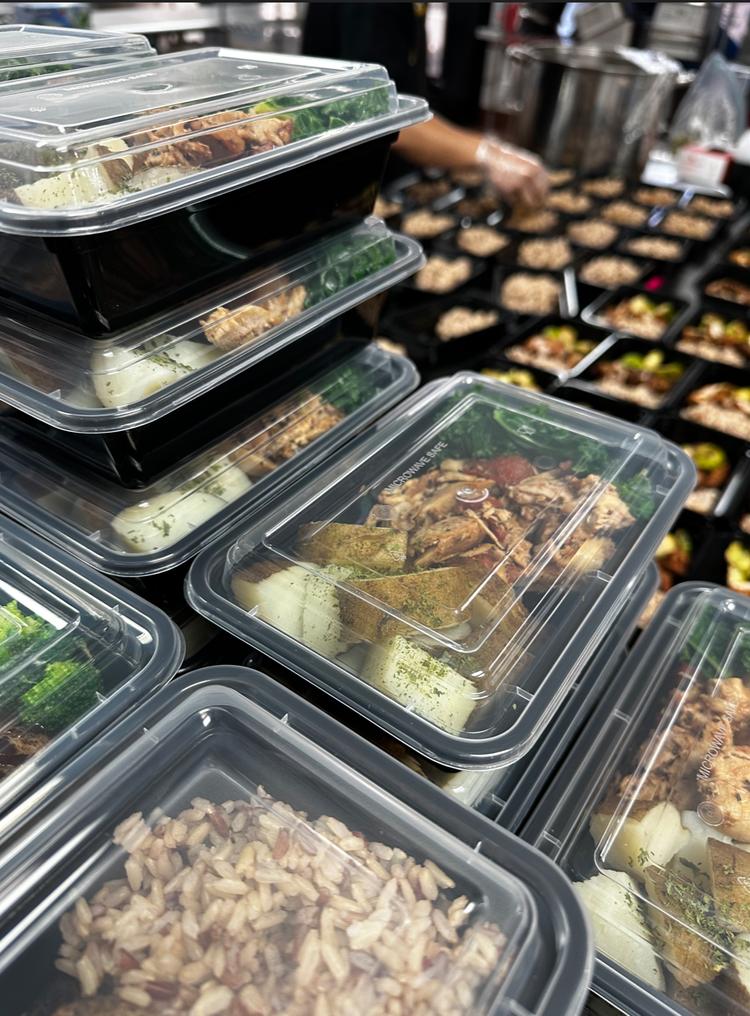 Stacked prepared meal containers from Fit For You Guam