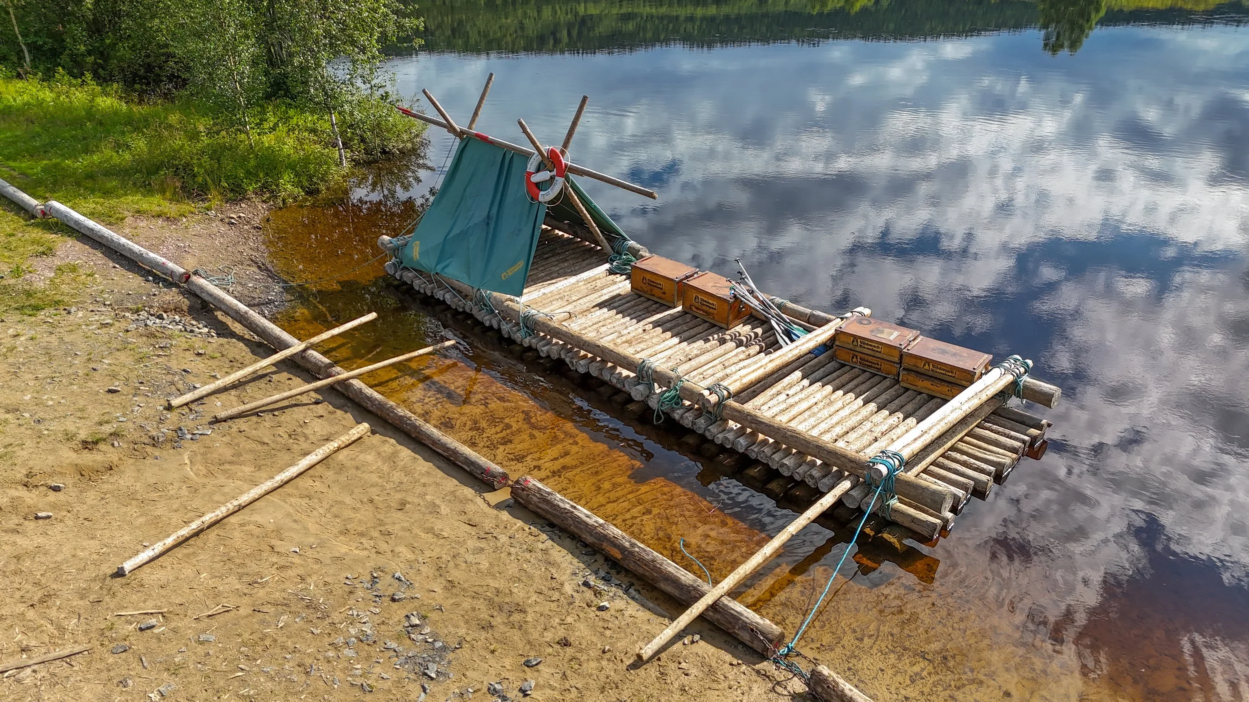 Our completed timber raft with one covered end sat waiting on the shores of the river