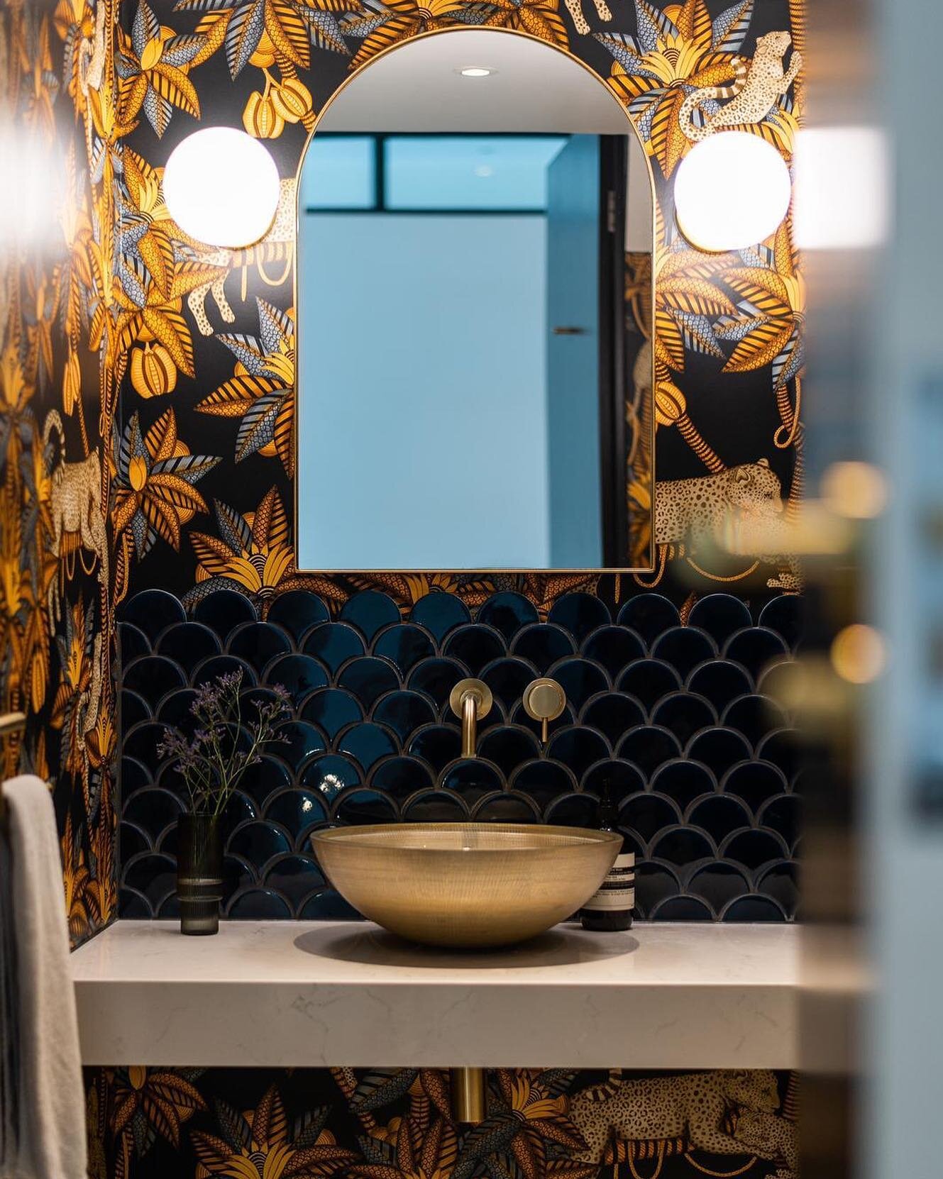 Adding opulence and ambience with tile, lighting and wallpaper choices.

Interior design: @colour_interiors_ltd 
Architect: @adearchitecture 
Wallpaper: @cole_and_son_wallpapers
Basin and taps: @cphartbathrooms 
Tiles: @artisansofdevizes 
Mirror: @he