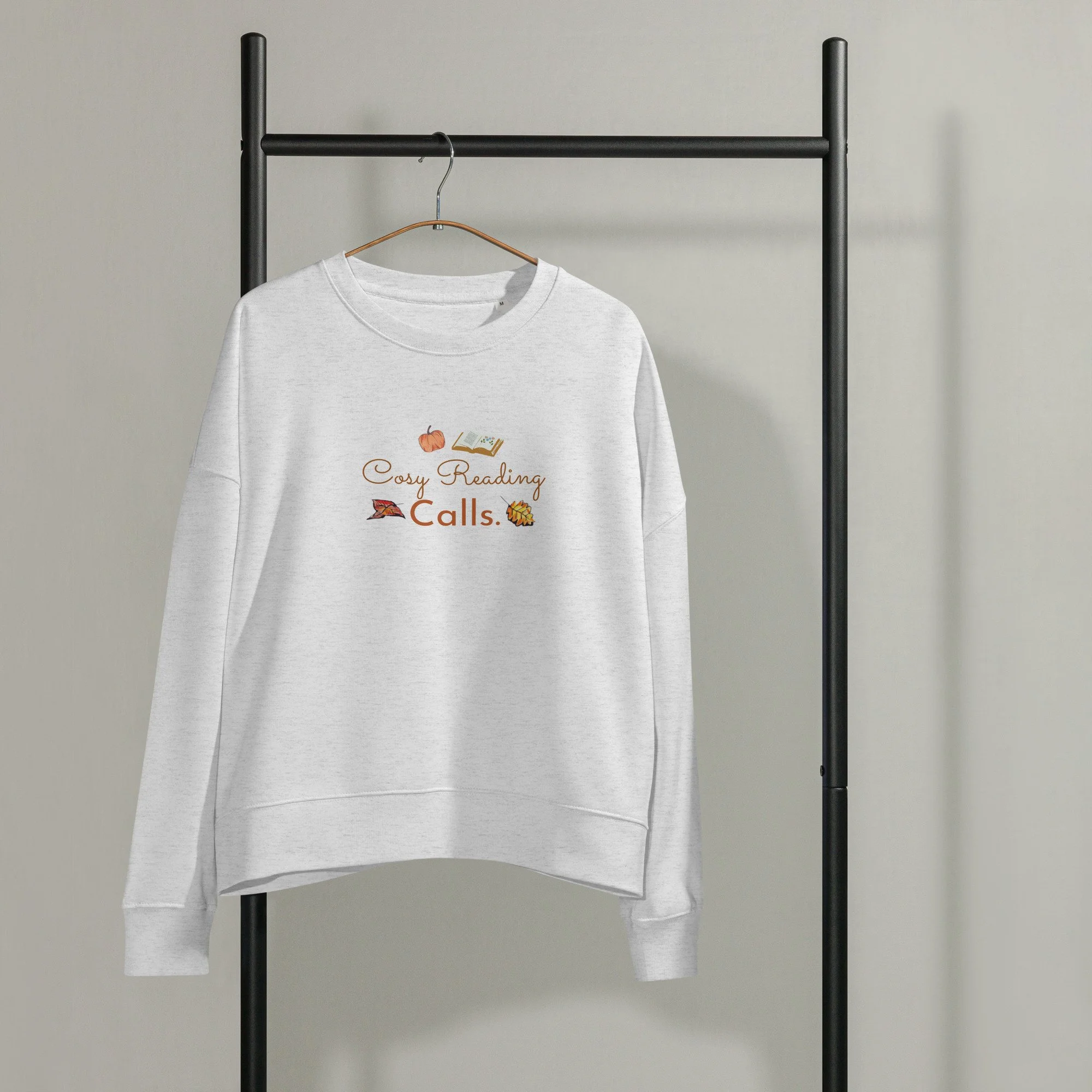 Heather grey 'Cosy Reading Calls' organic sweatshirt on a clothes rail